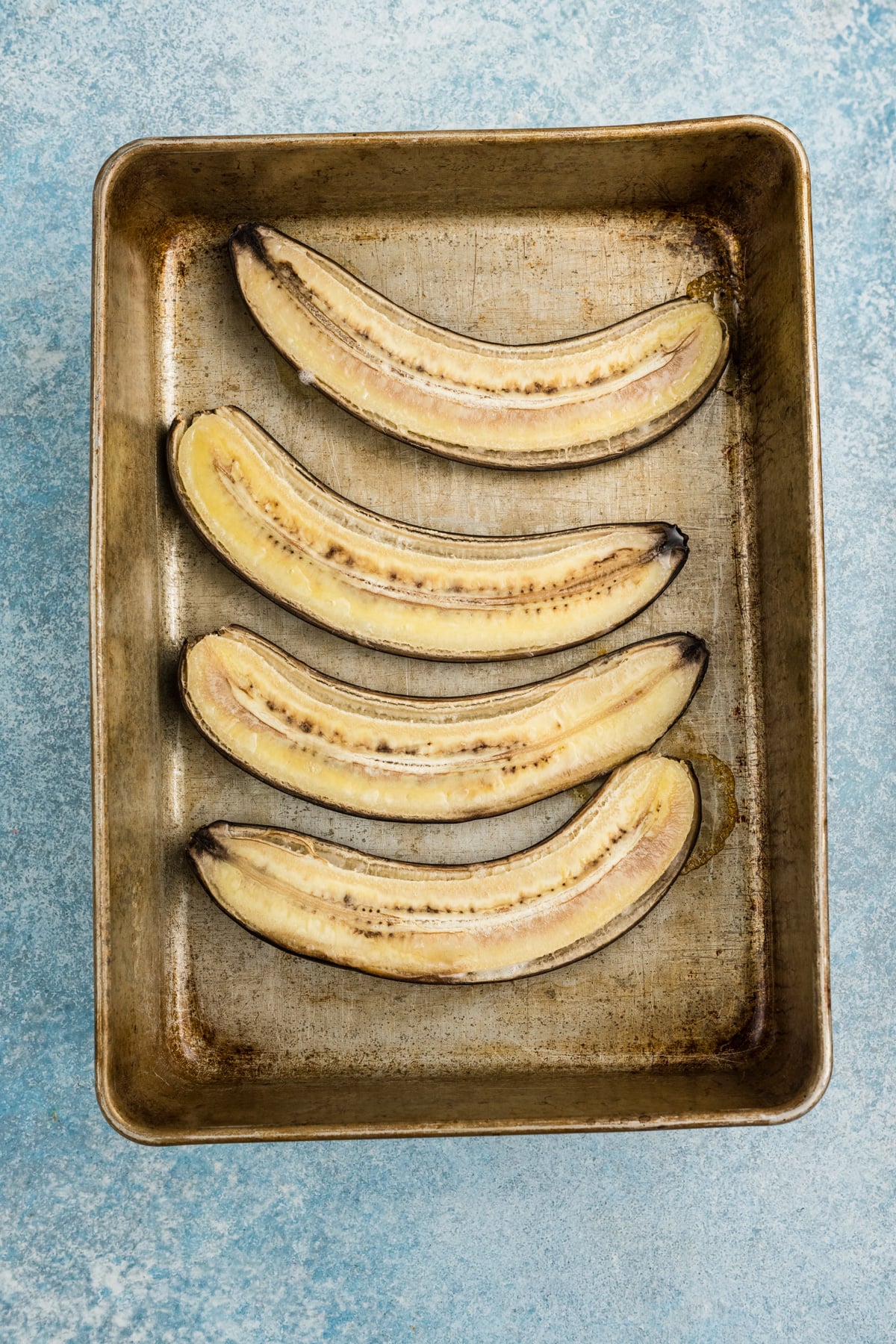 Bananas sliced and put on a sheet pan.