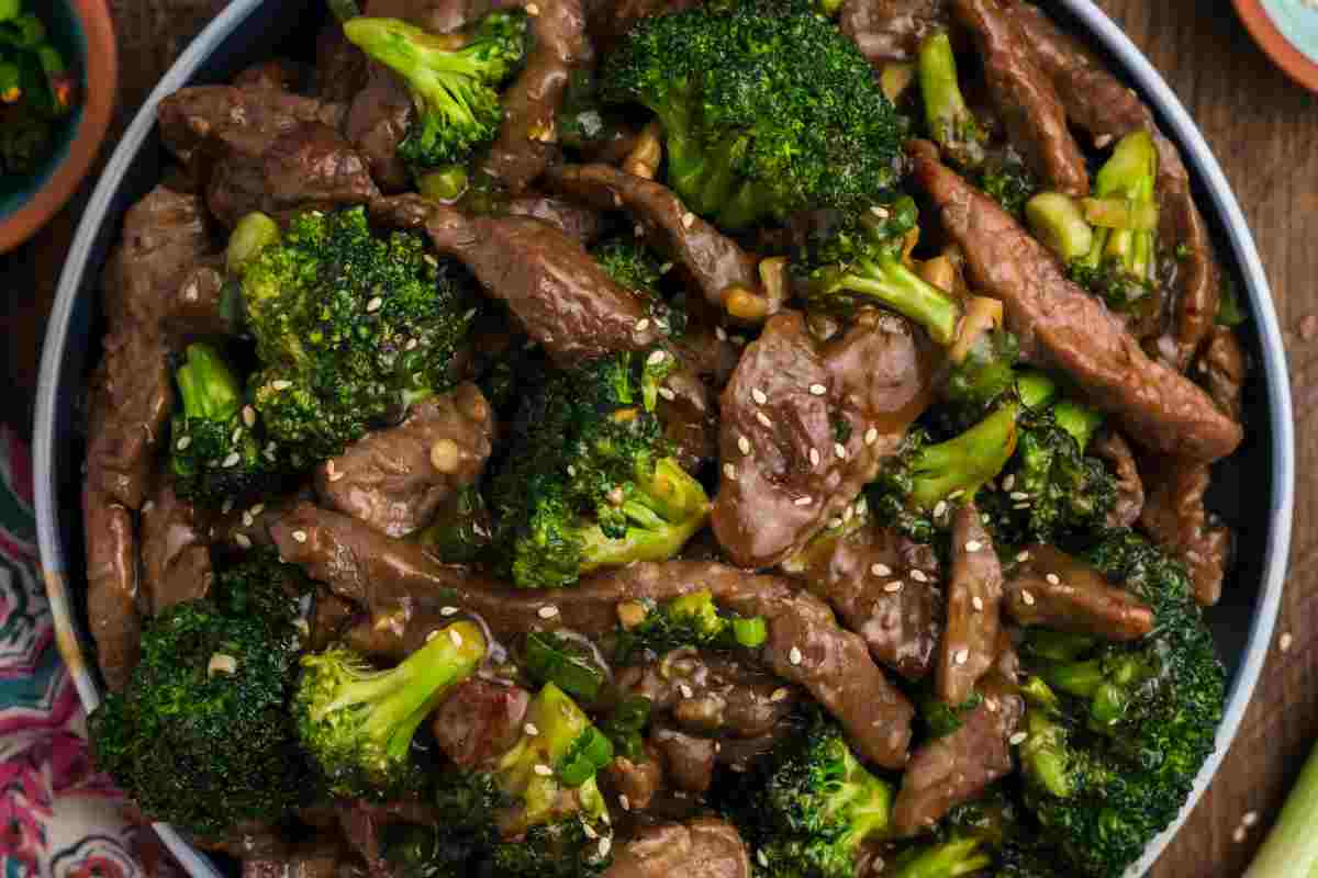 A plate full of Beef With Garlic Sauce and broccoli.