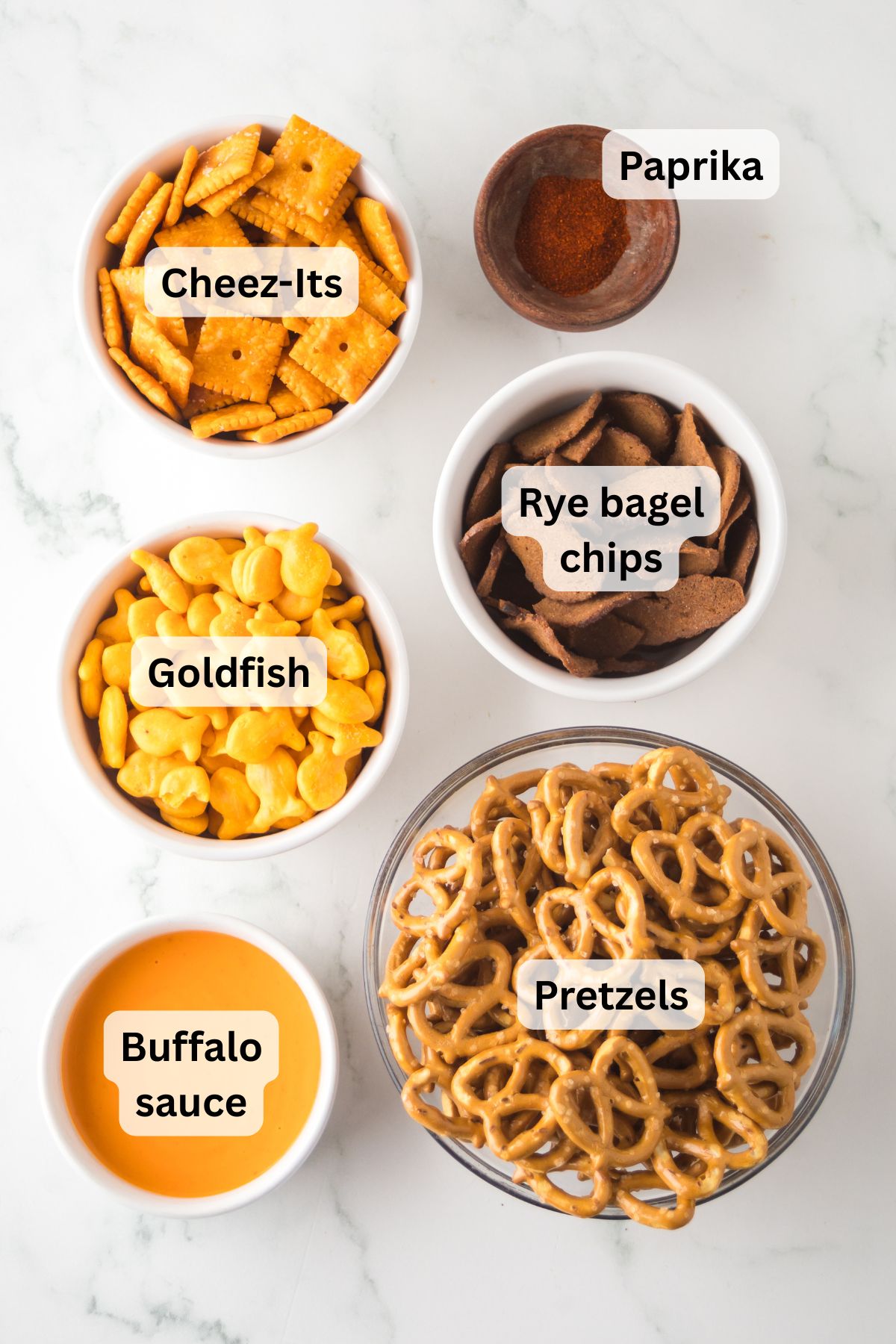 Ingredients to make Buffalo snack mix on the table with labels to identify each one.