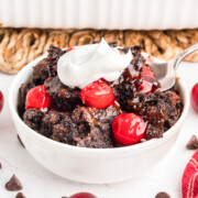 Chocolate cherry dump cake in a bowl.