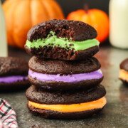 Stacked chocolate sandwich cookies with a bite taken out of the top cookie.