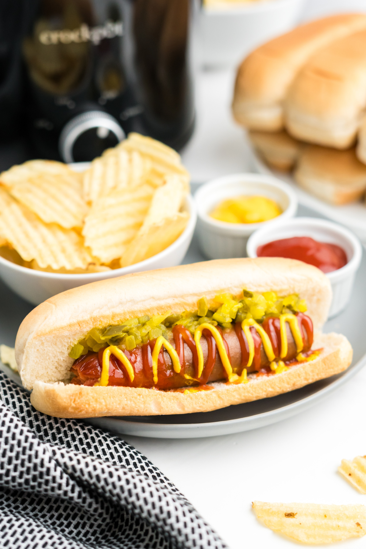 A hot dog with ketchup, mustard and relish on it.