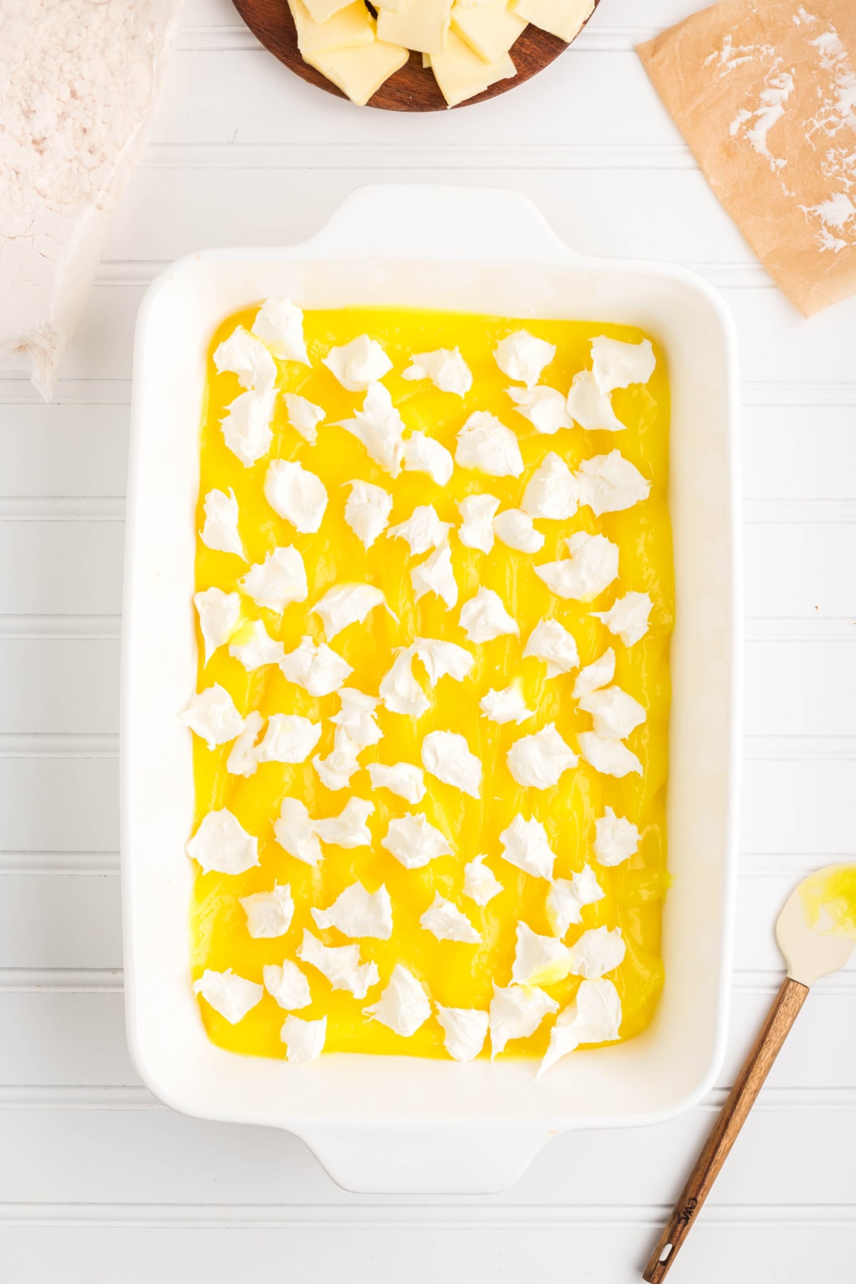 Cream cheese dollops on top of the lemon pie filling.