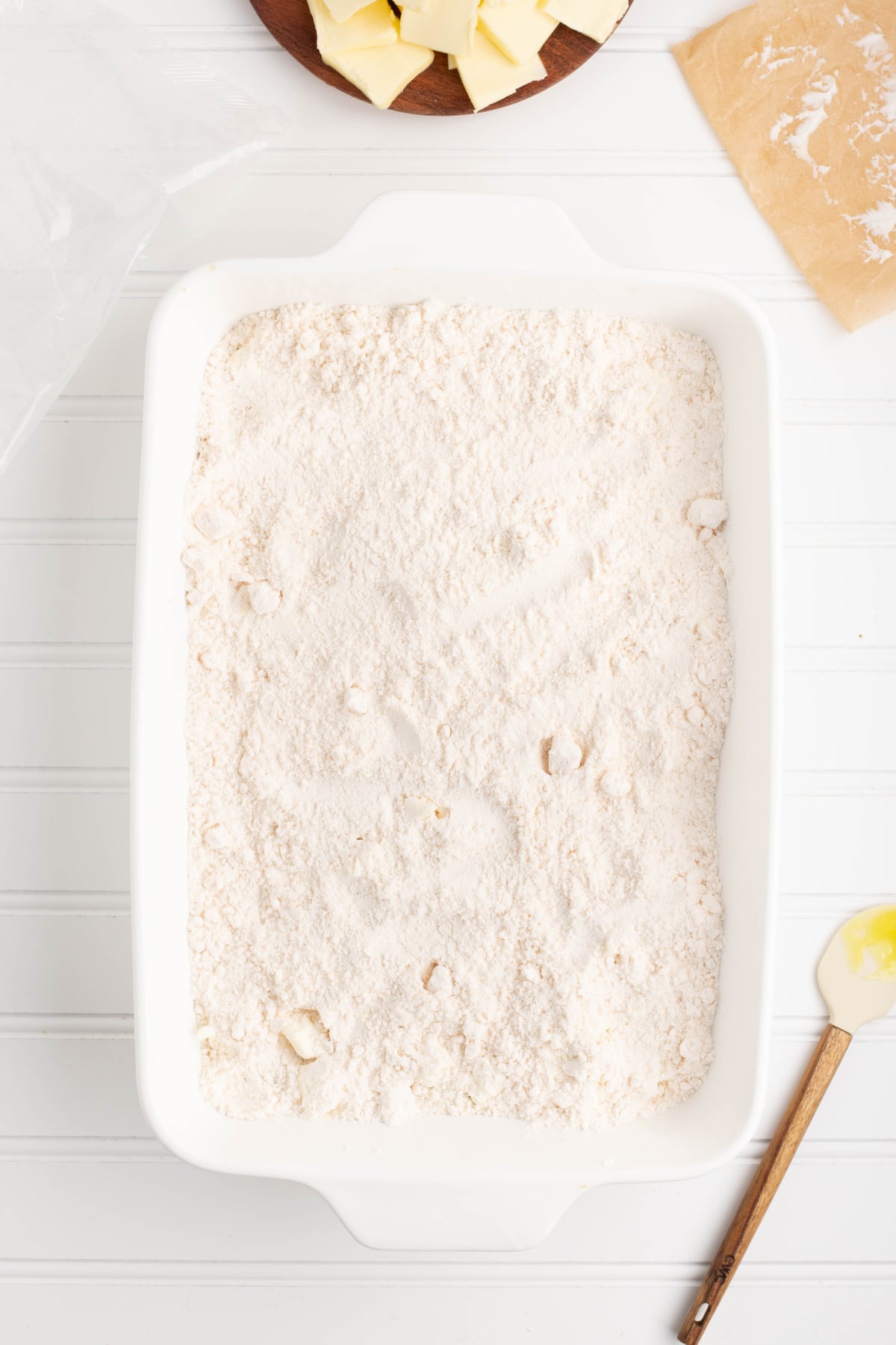 The cake mix spread on top of the lemon and cream cheese layer.