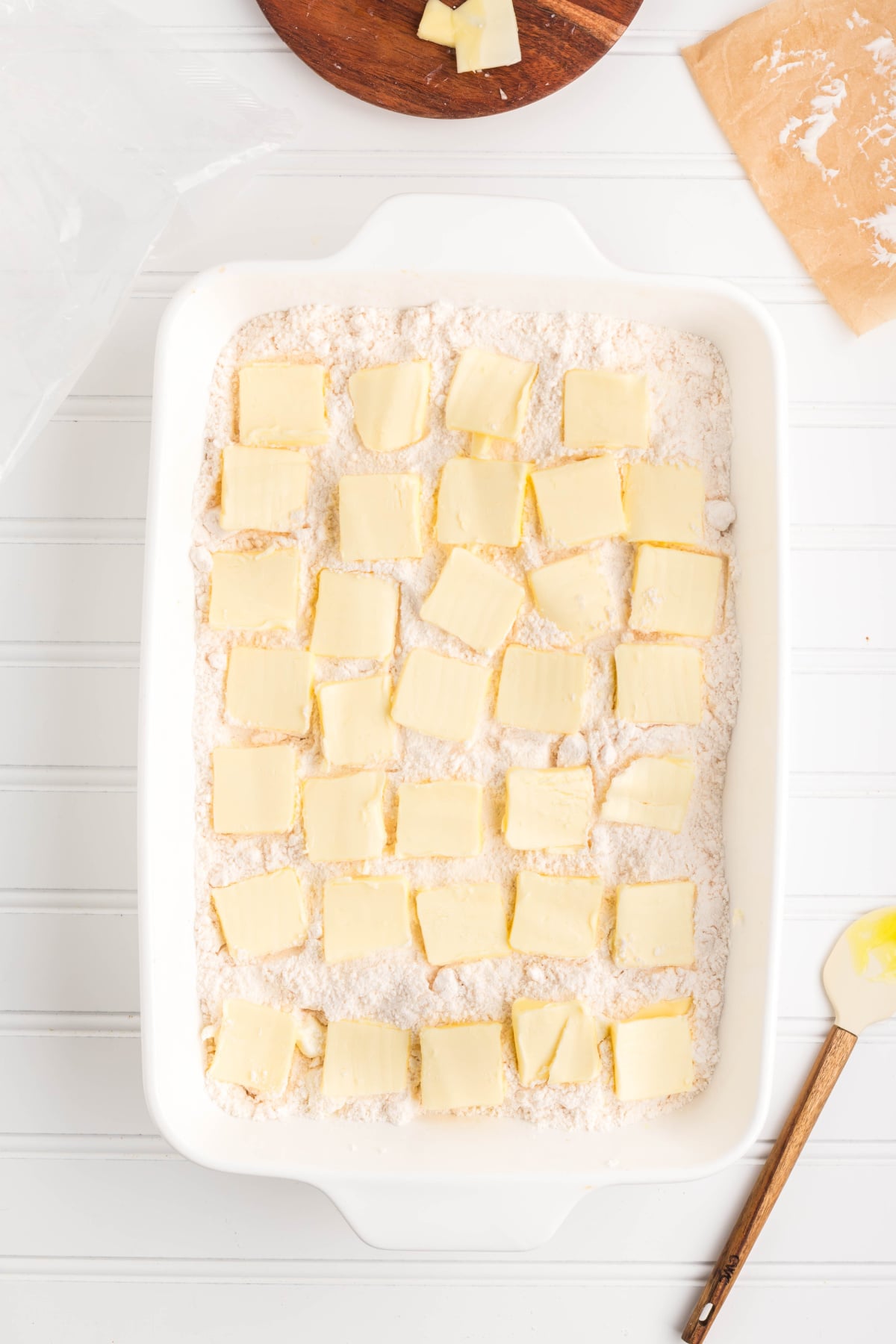 Slices of butter on top of the cake mixture.