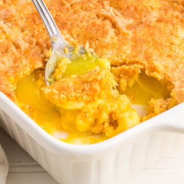 Lemon cream cheese dump cake with a spoon scooping some out.