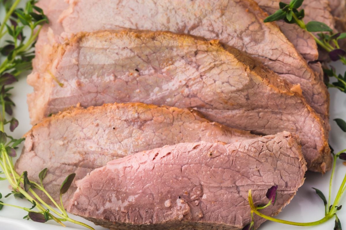 Slices of roast on plate.