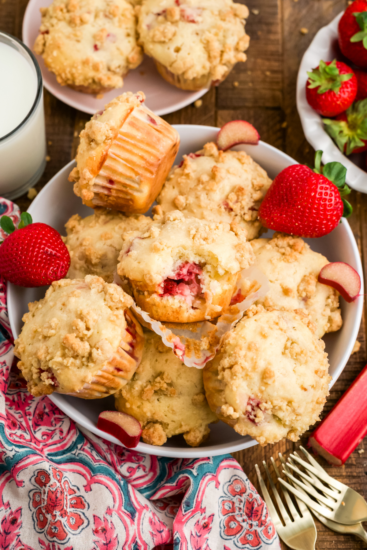 A bowl filled with strawberry rhubarb muffins. 
