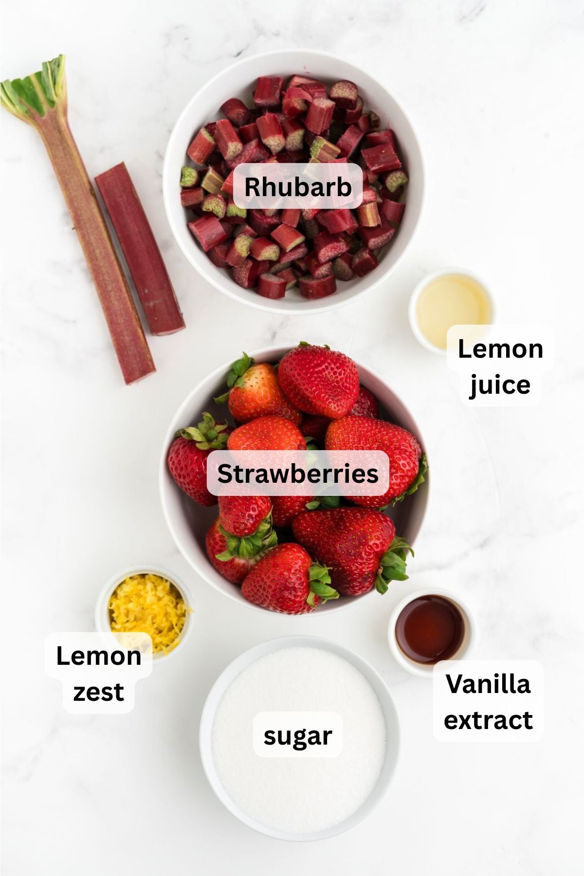Ingredients to make strawberry and rhubarb preserves on a table.