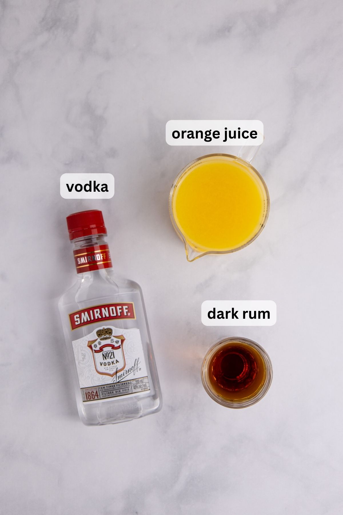 All of the ingredients needed to make a Brass Monkey on a table.