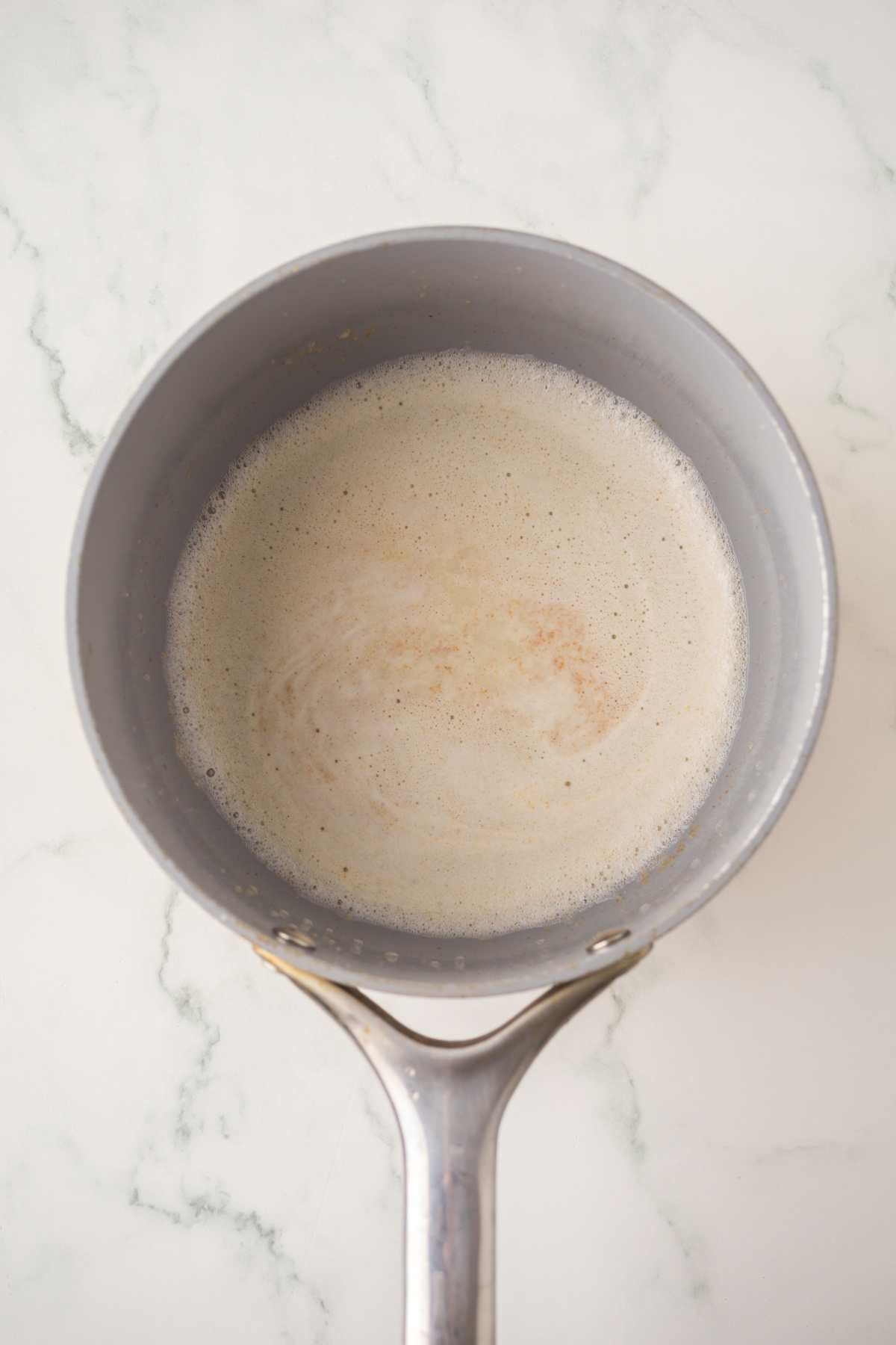 brown butter foaming in saucepan