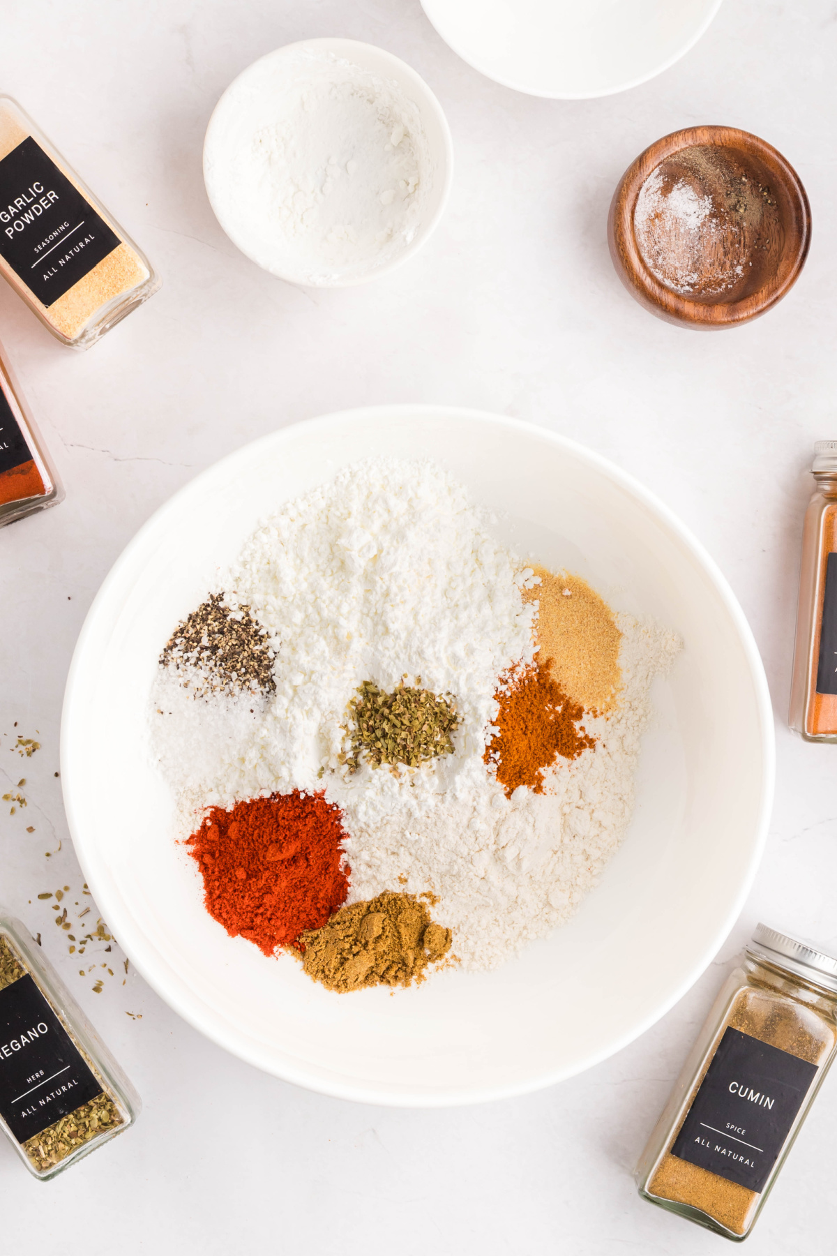 Flour, cornstarch and all the spices combined in a bowl.