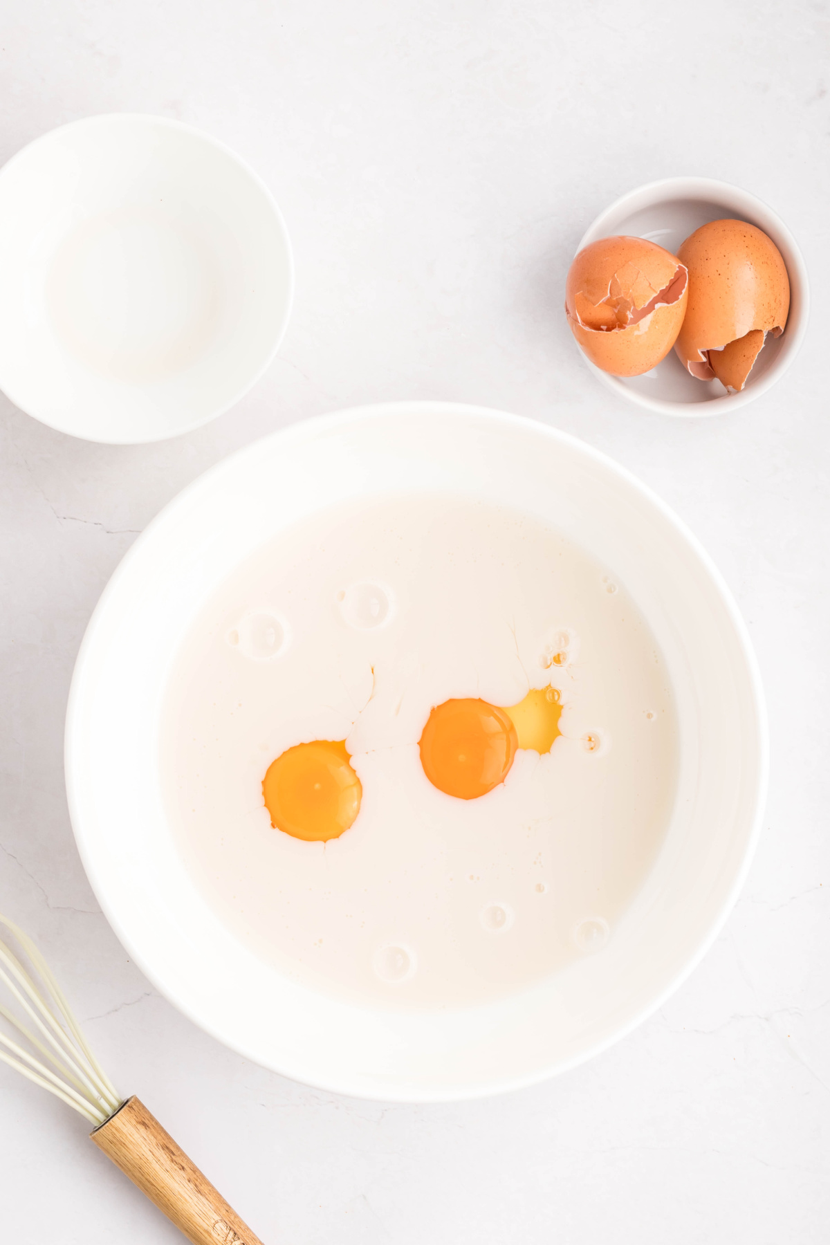 Milk and eggs in a bowl.