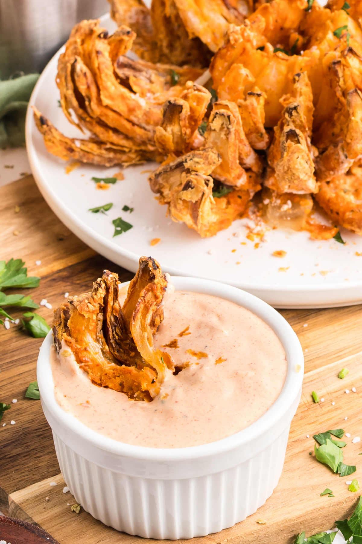 A piece of onion in dipping sauce.