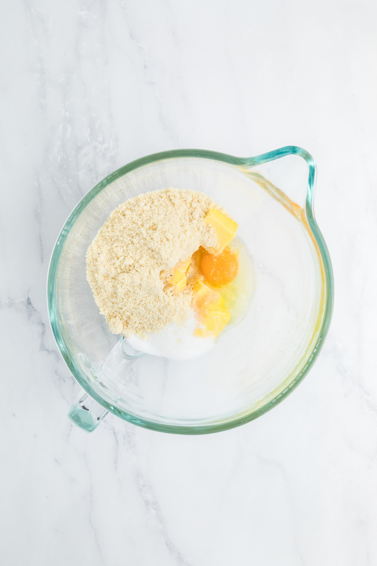 Ingredients for the almond filling added to a mixing bowl.