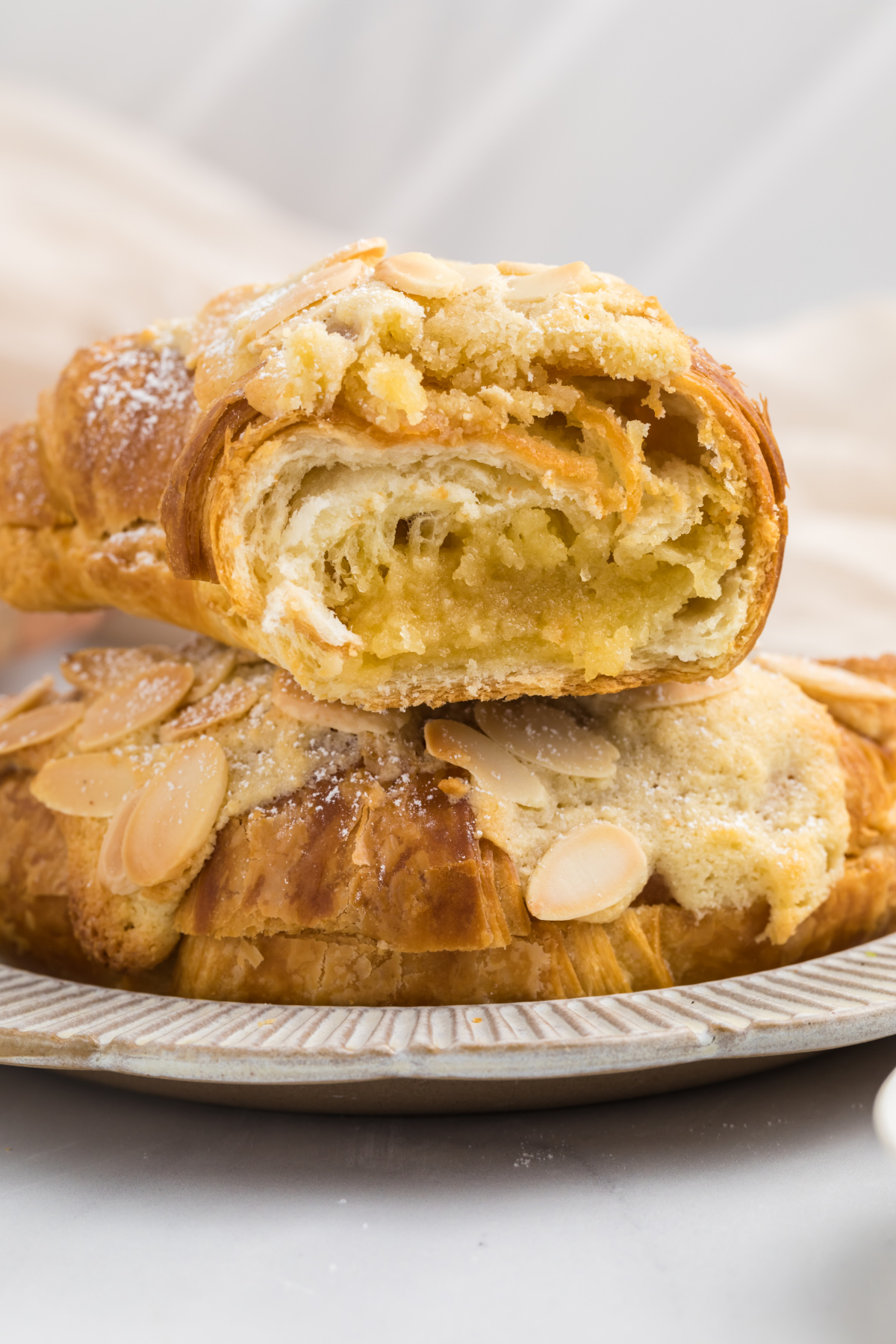 A broken open croissant on a plate.