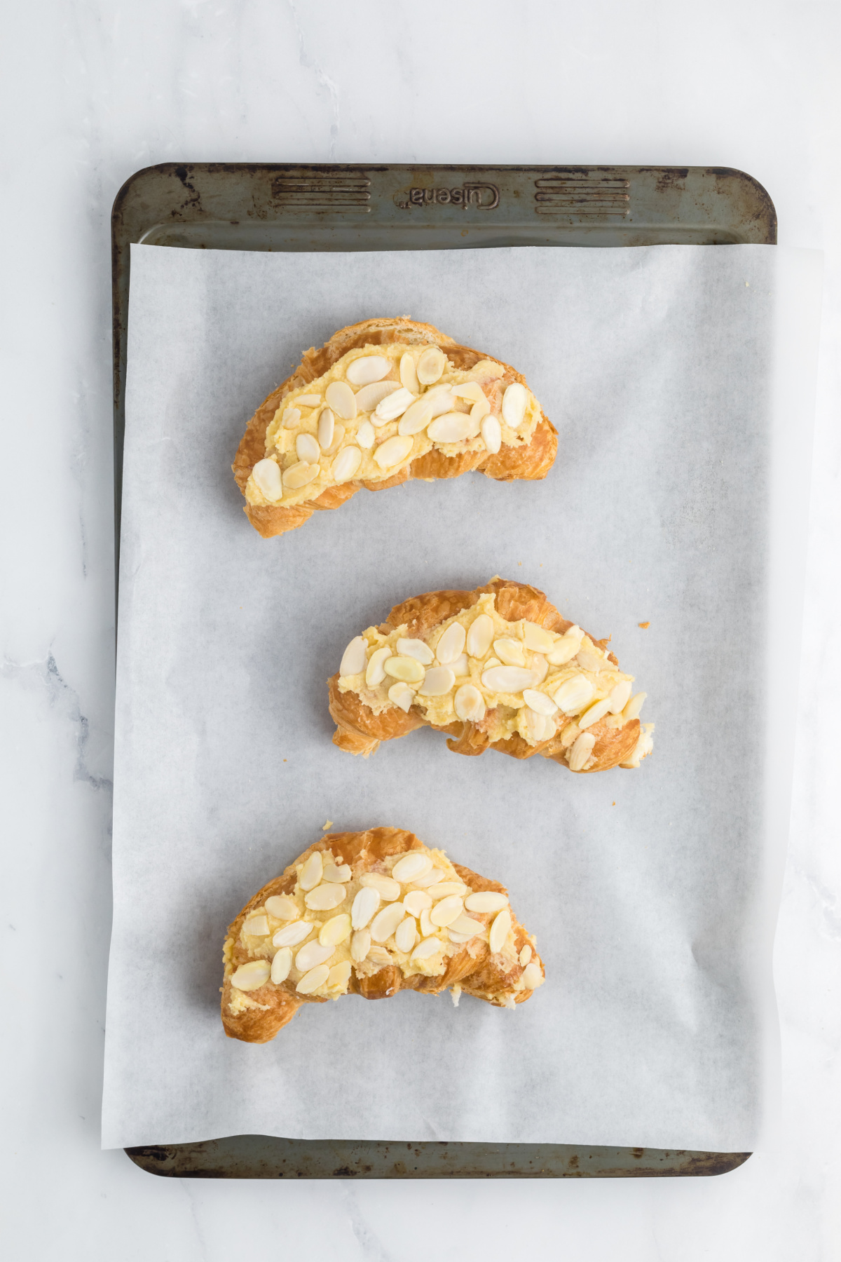 The top halves spread with the remaining filling on top of the croissants.