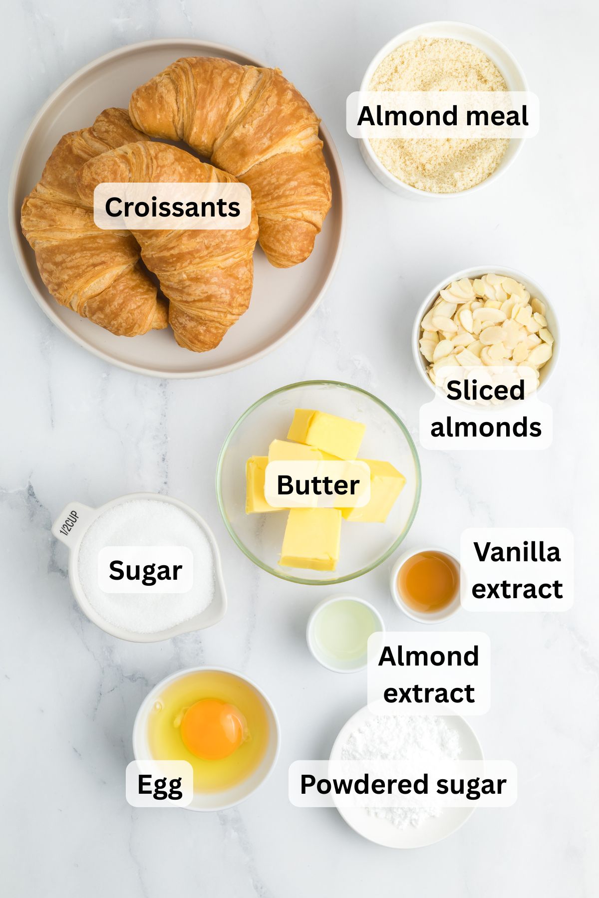 Ingredients to make these croissants in bowls on a table.