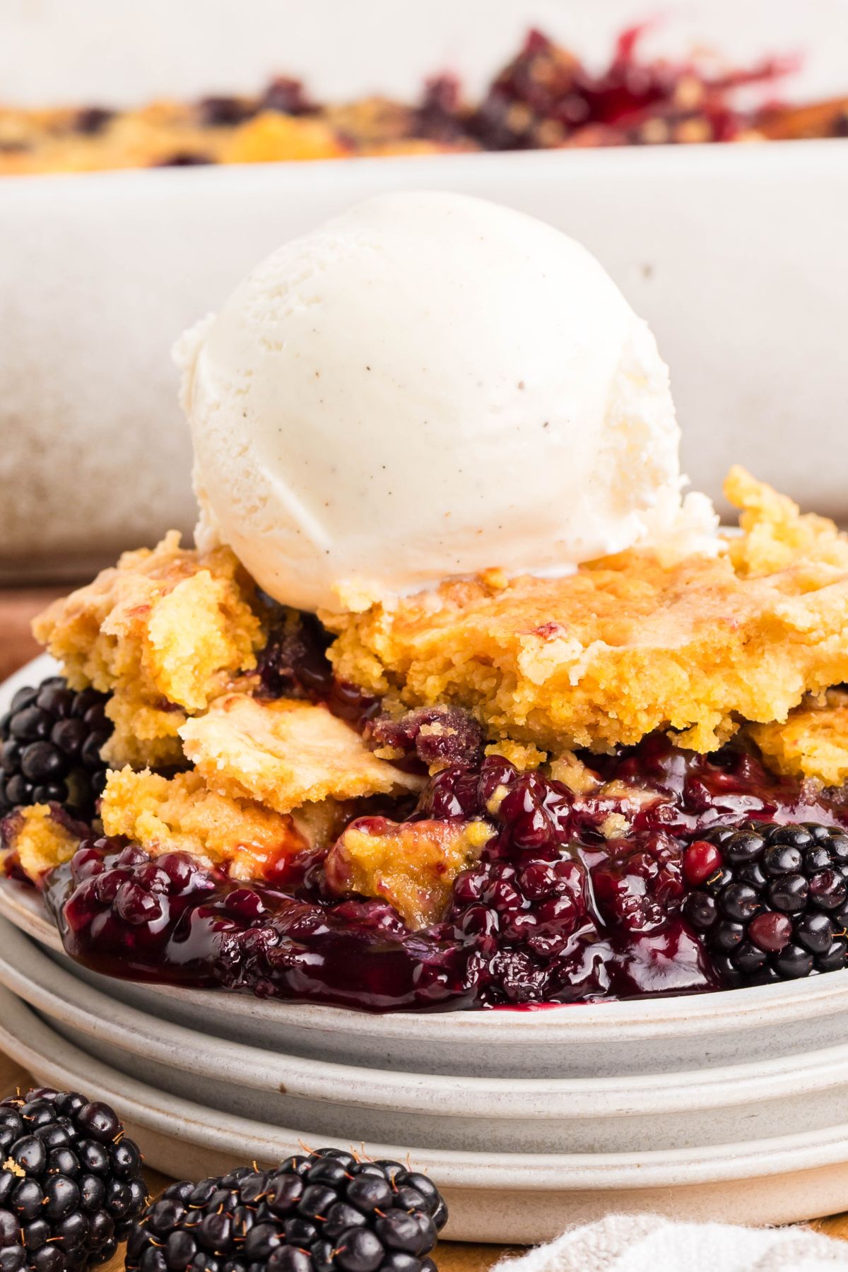 Dump cake with blackberry filling and ice cream on top.