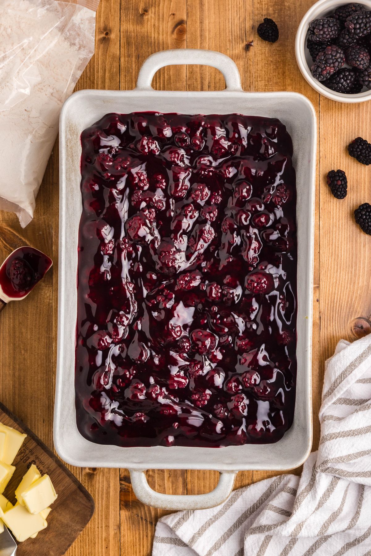 Blackberry pie filling in the bottom of a baking dish.