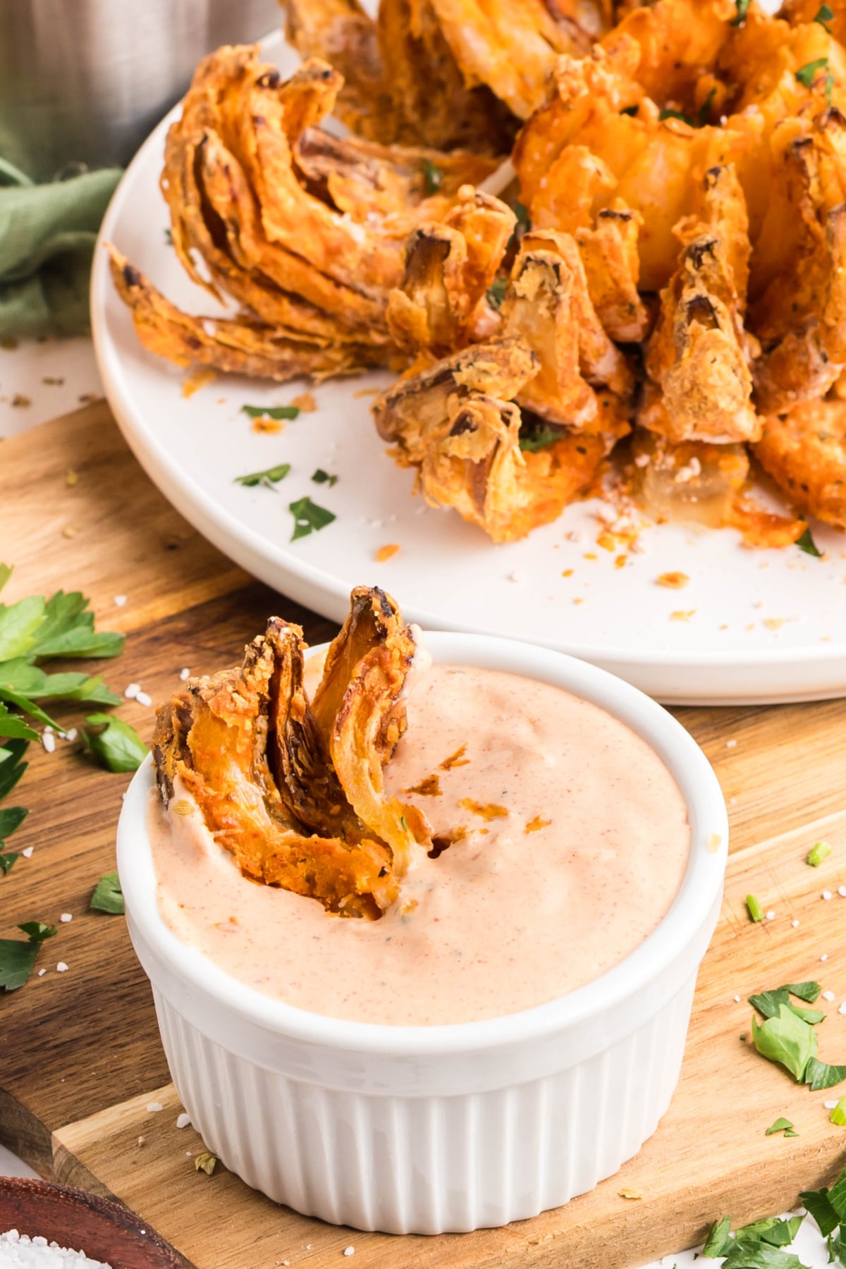 A ramekin filled with sauce being dipped into.