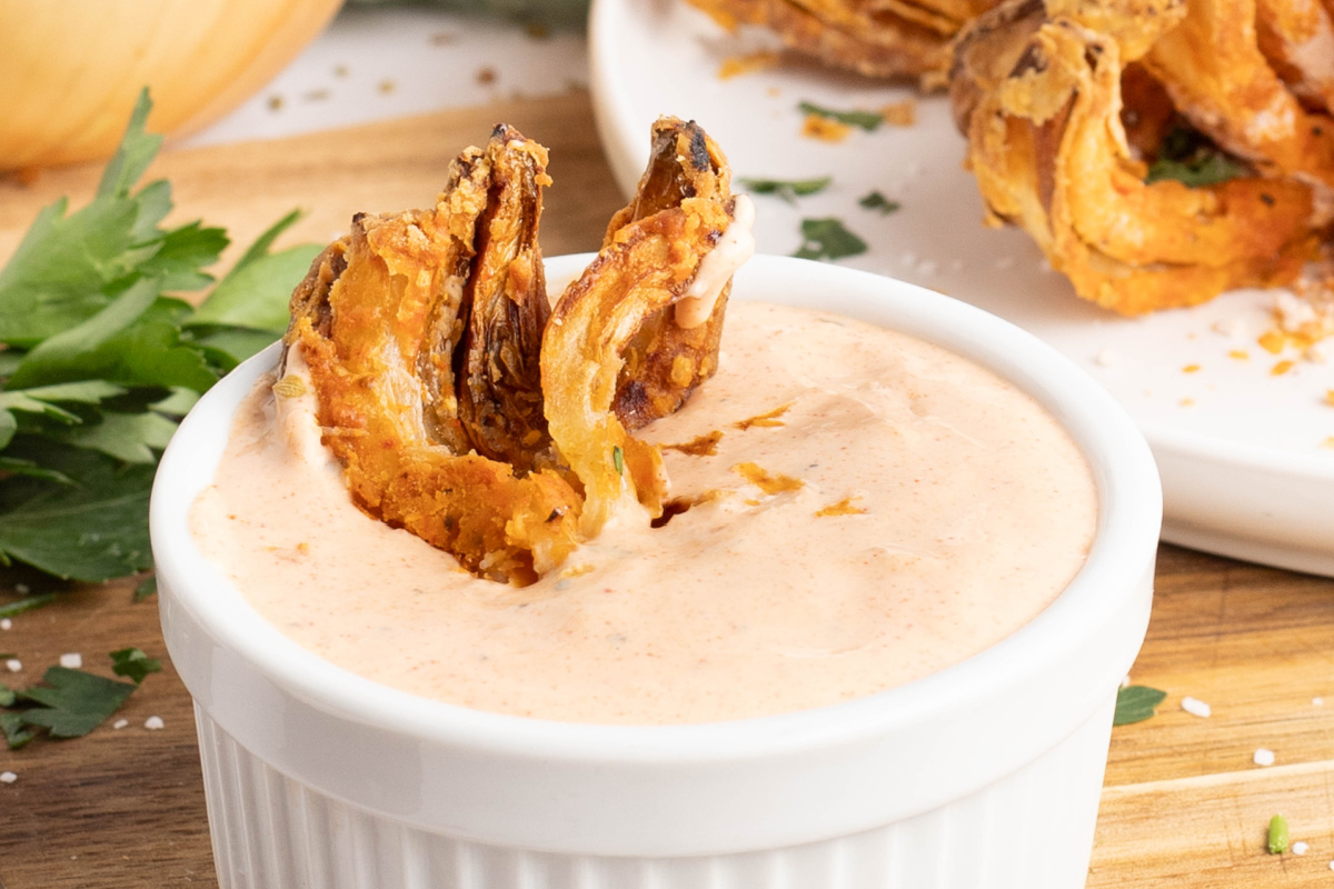 Blooming onion in a cup of dip