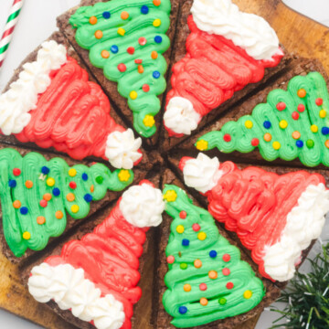 Decorated brownies on cutting board.