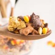 Halloween Chex Mix on a wooden spoon.