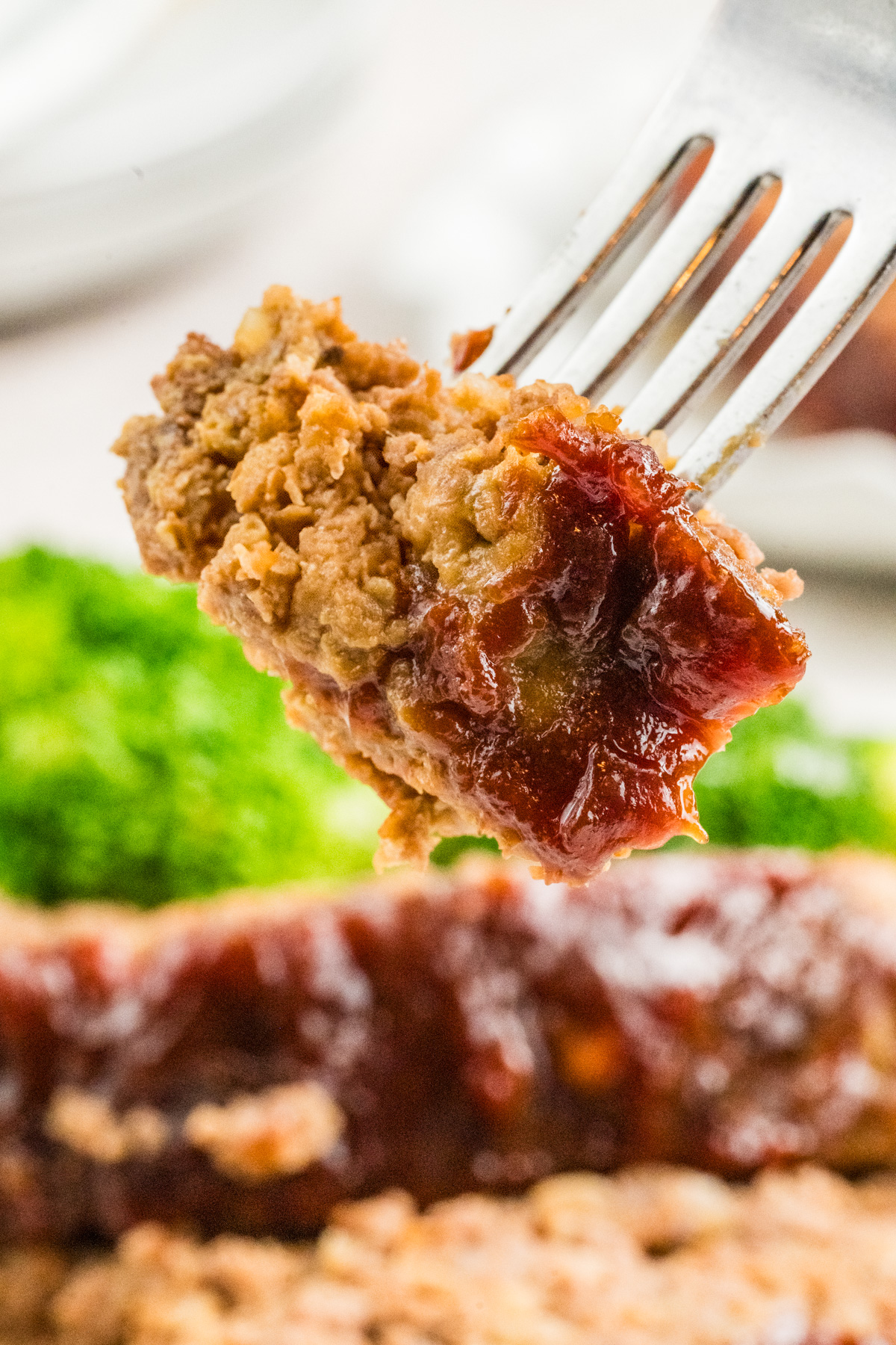 A piece of meatloaf on a fork.