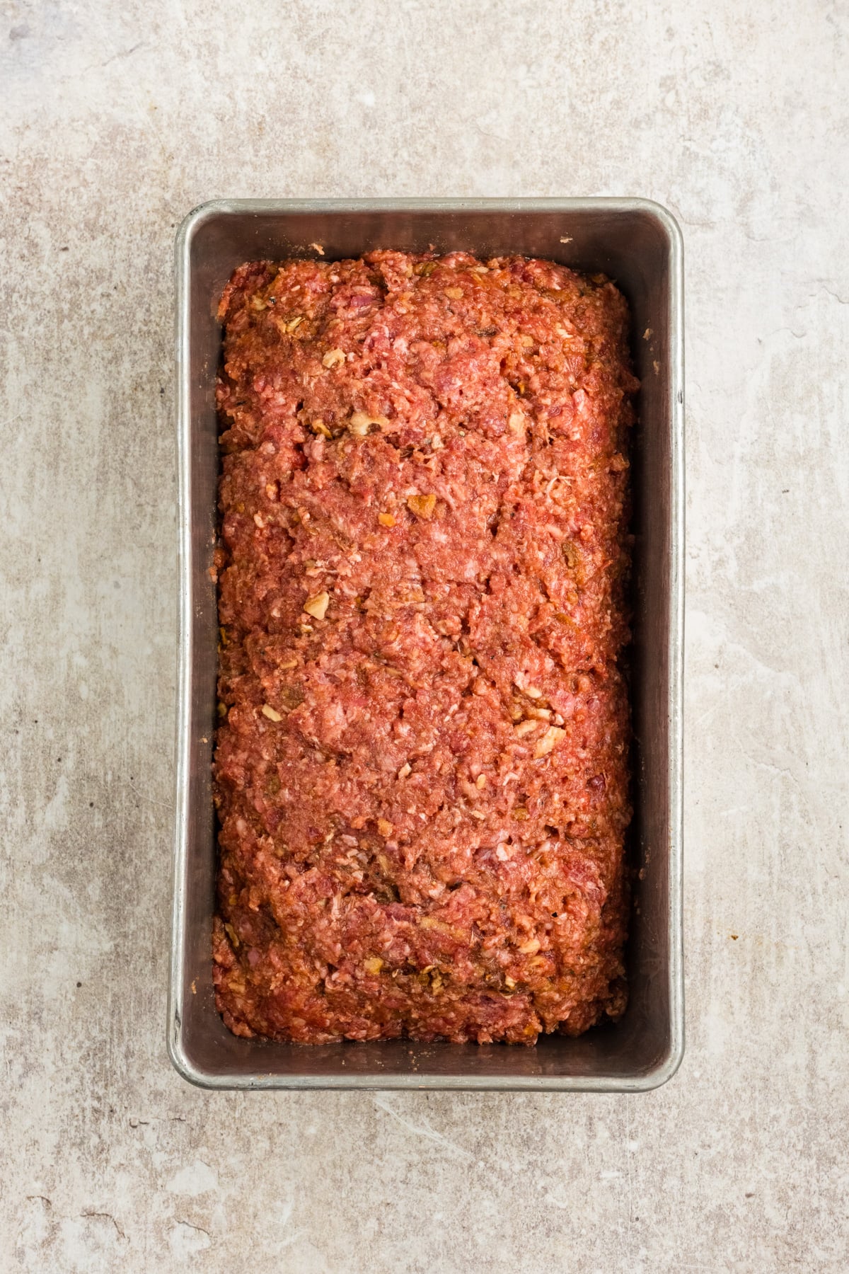 Meatloaf mixture placed in a pan.