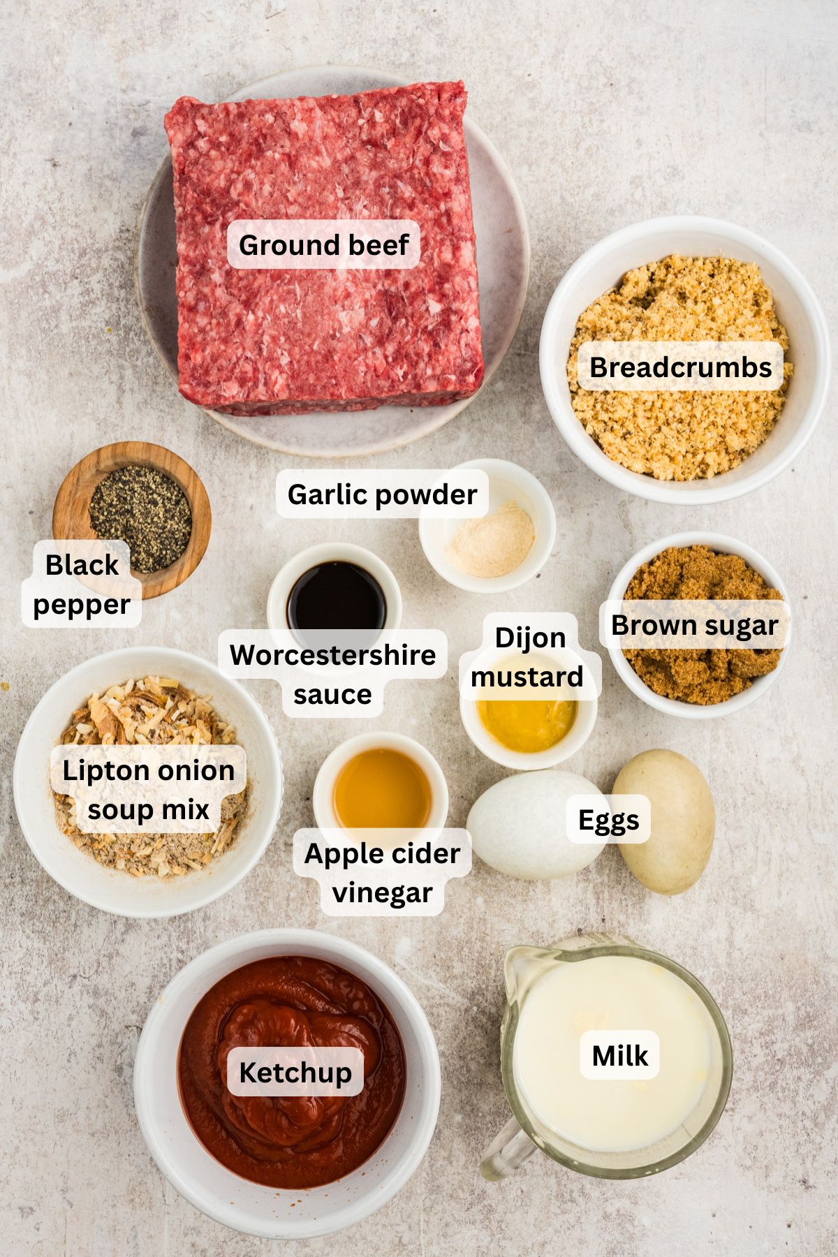 Ingredients to make this meatloaf in bowls on a table.