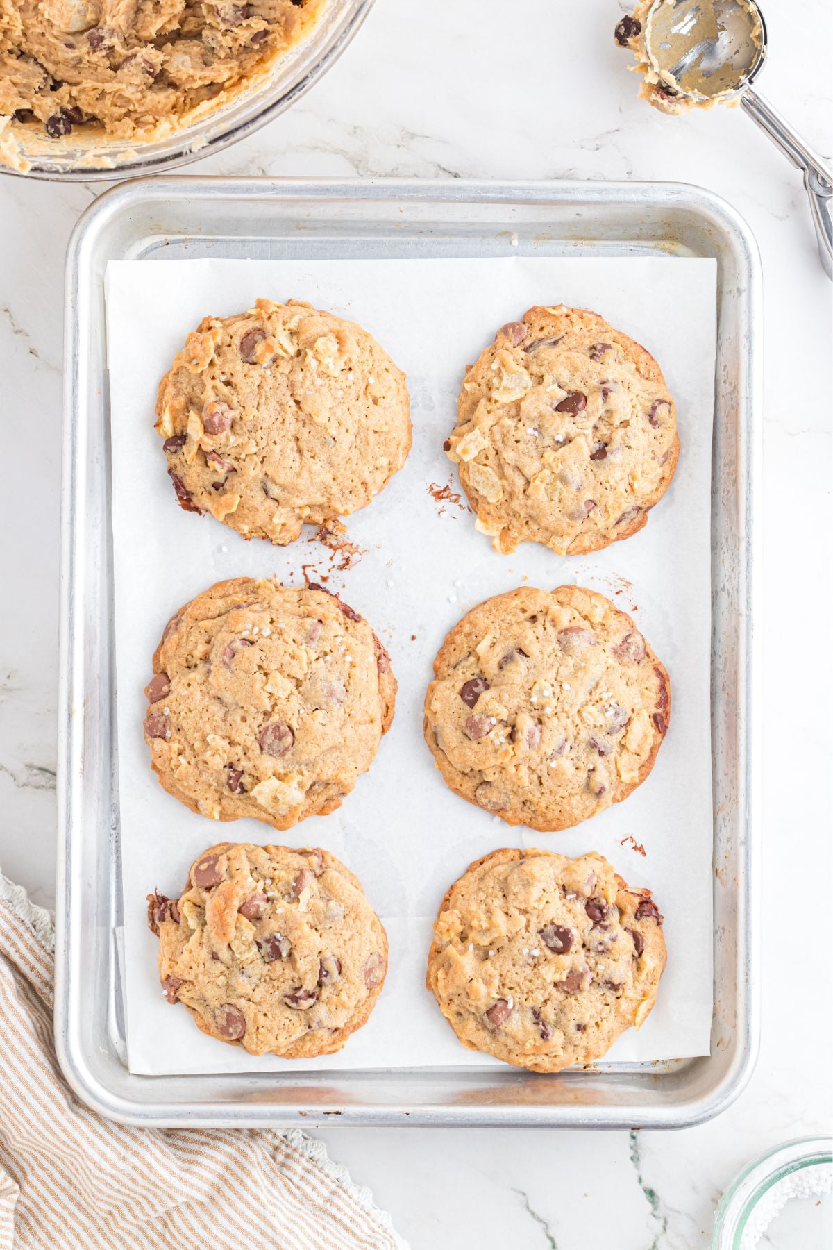 The potato chip chocolate chip cookies cooked and cooling on the baking sheet.