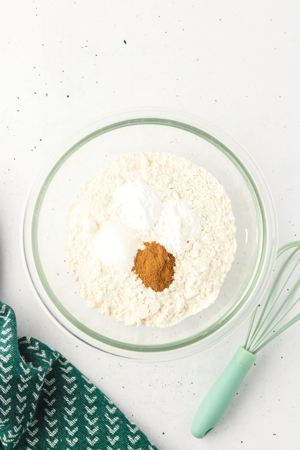 Cinnamon, baking soda, baking powder and salt in a bowl.
