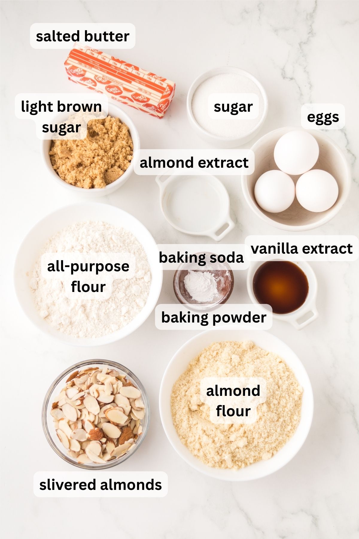 Ingredients to make these cookie bars in bowls on a table.