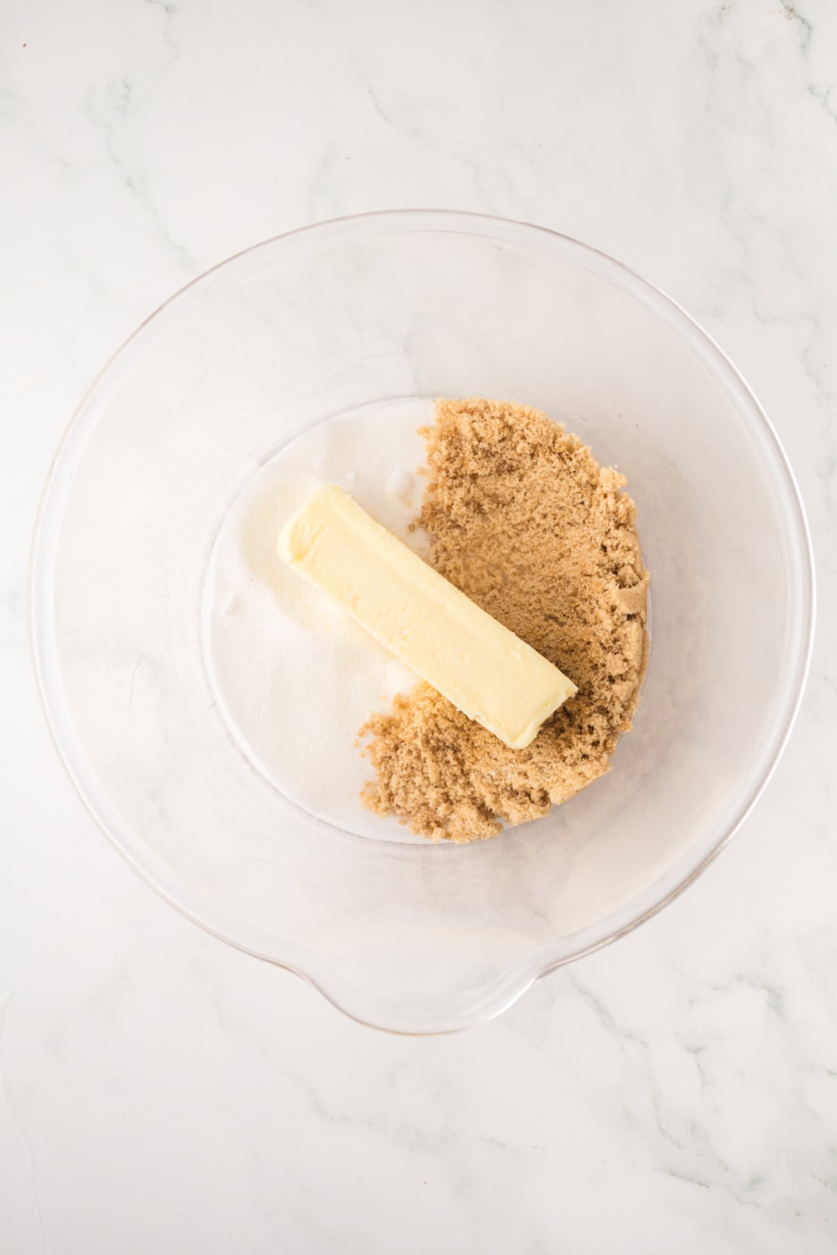 Butter with the brown and white sugar in a mixing bowl.