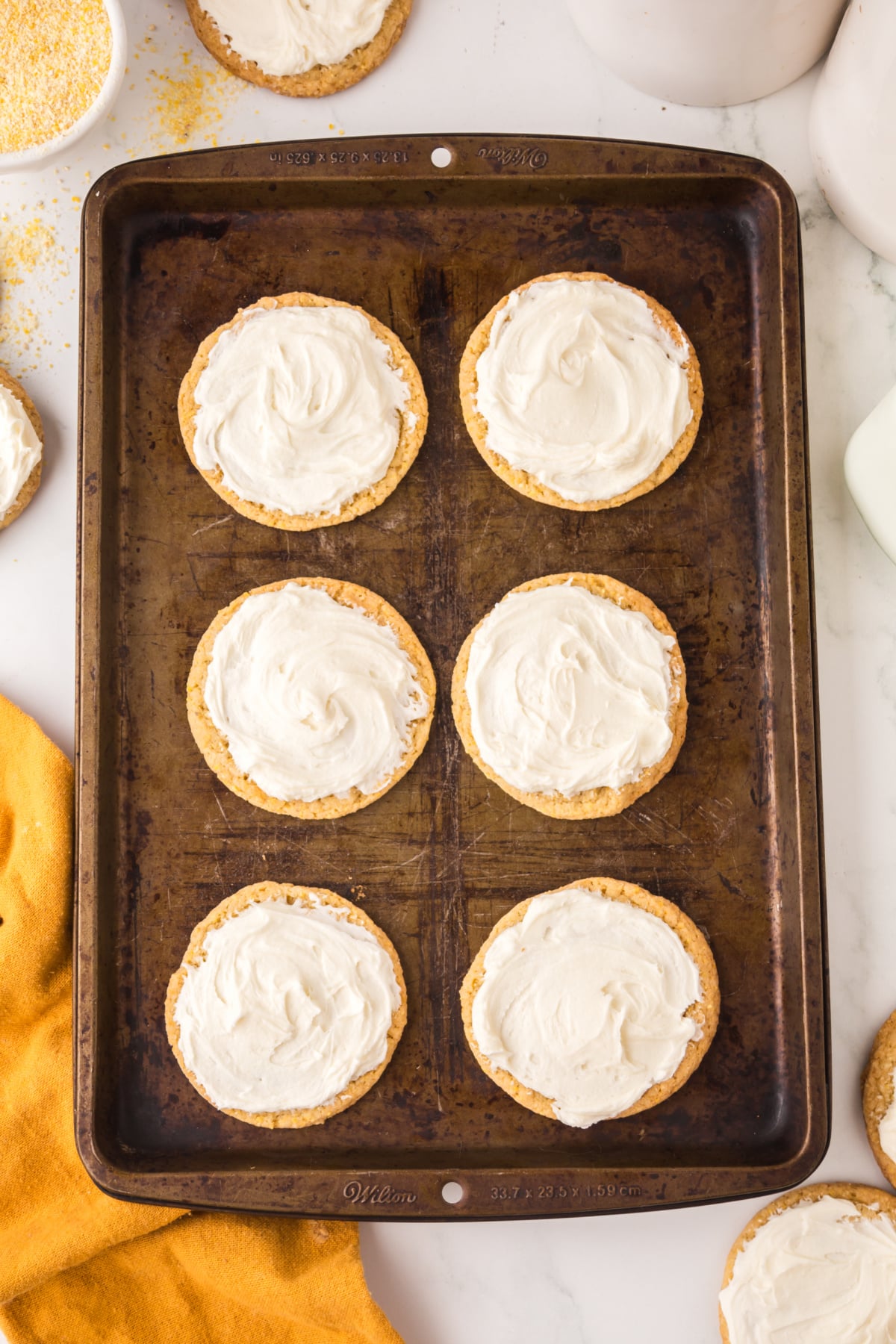 Frosting added to the top of the cookies.
