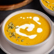Pumpkin carrot soup in a bowl.
