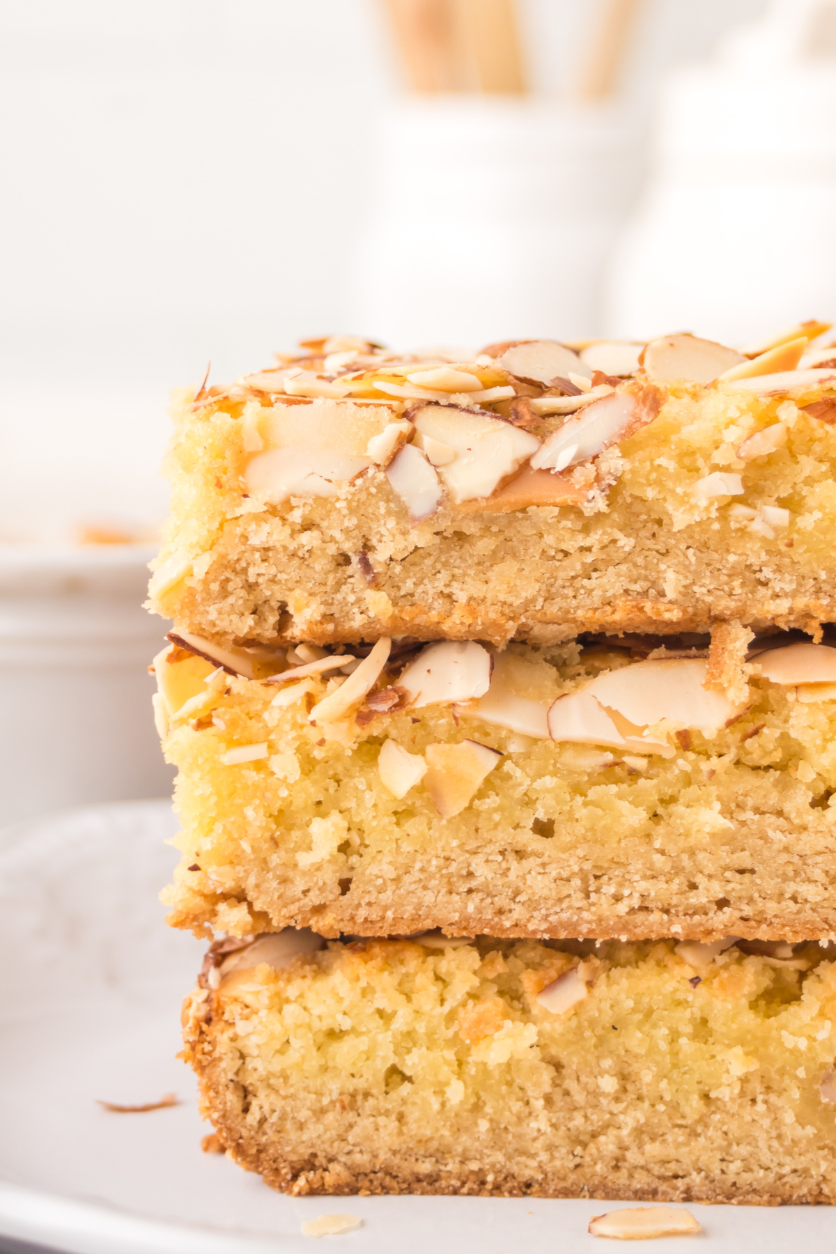 Cookie bar with almonds stacked on a plate.