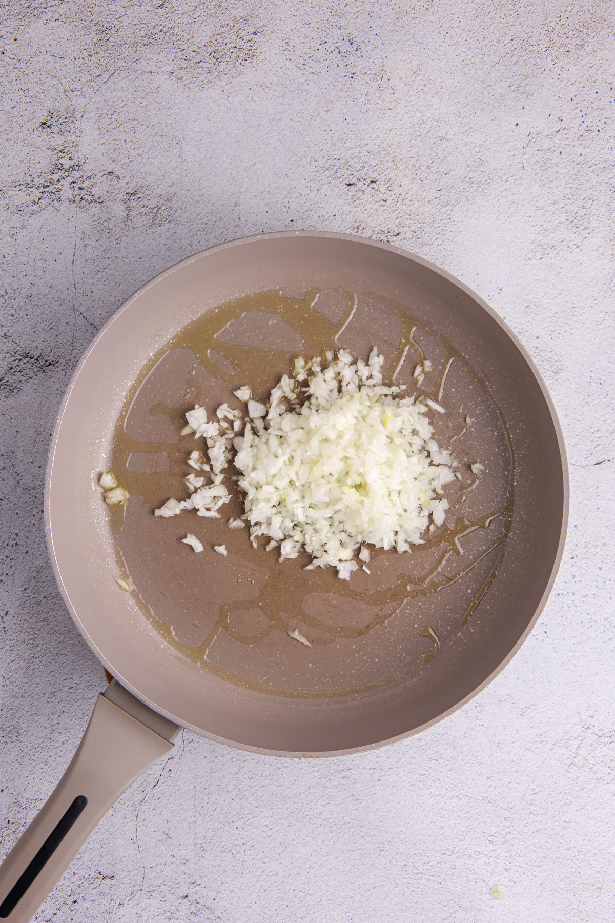 Onions and garlic sauteed in a pan.