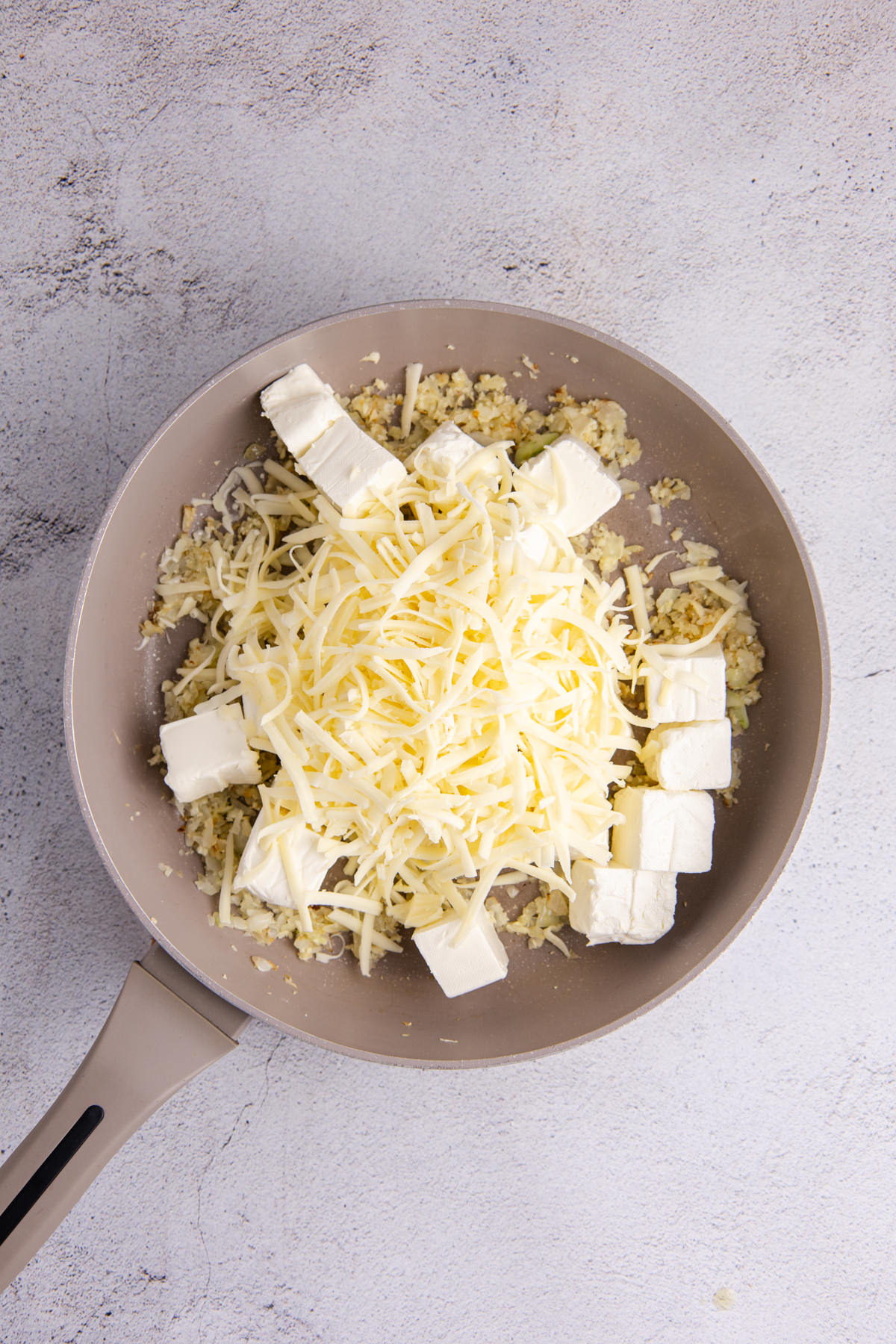 Cream cheese and mozzarella added to the pan.