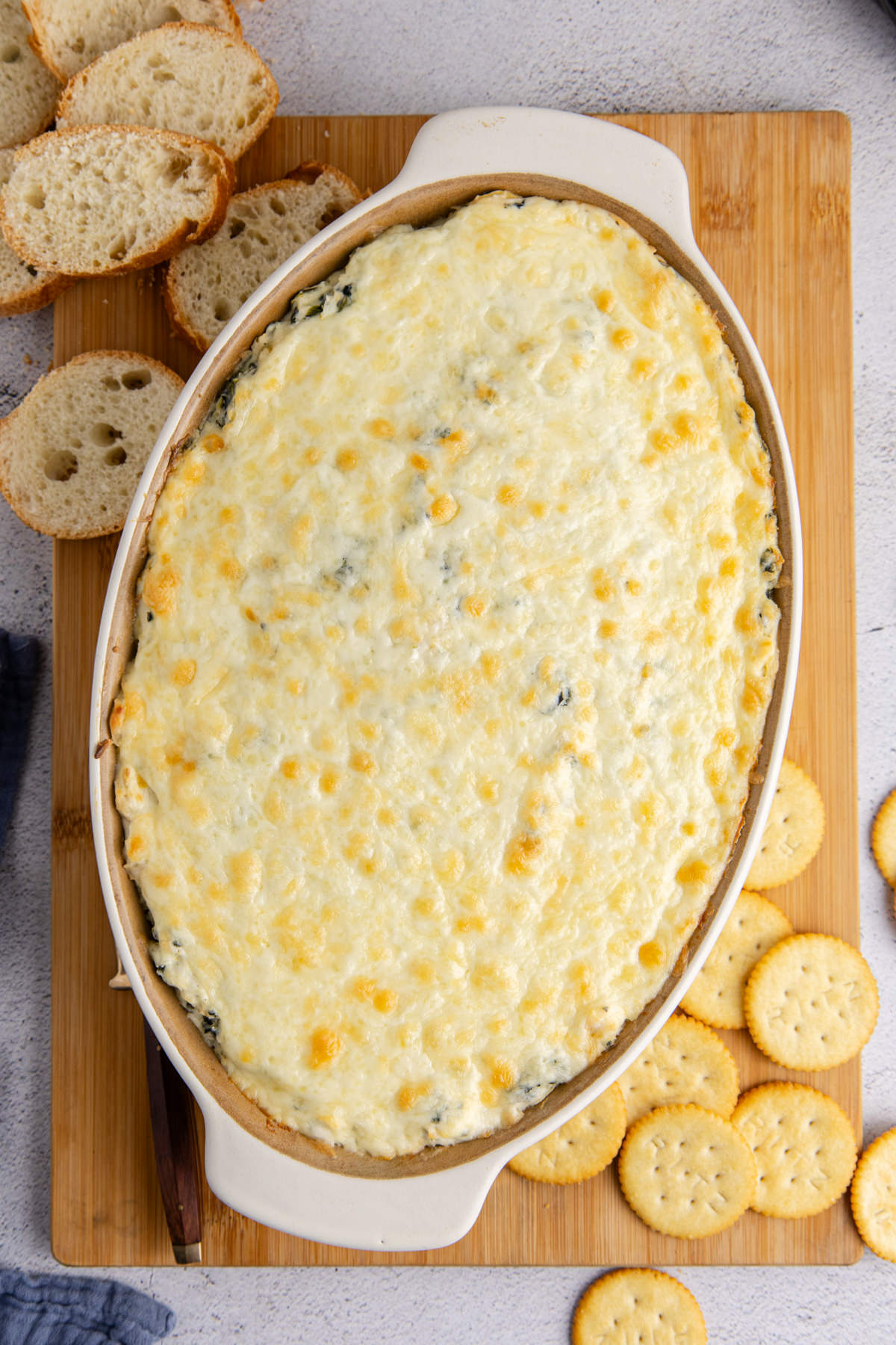 Cooked dip resting on a cutting board.