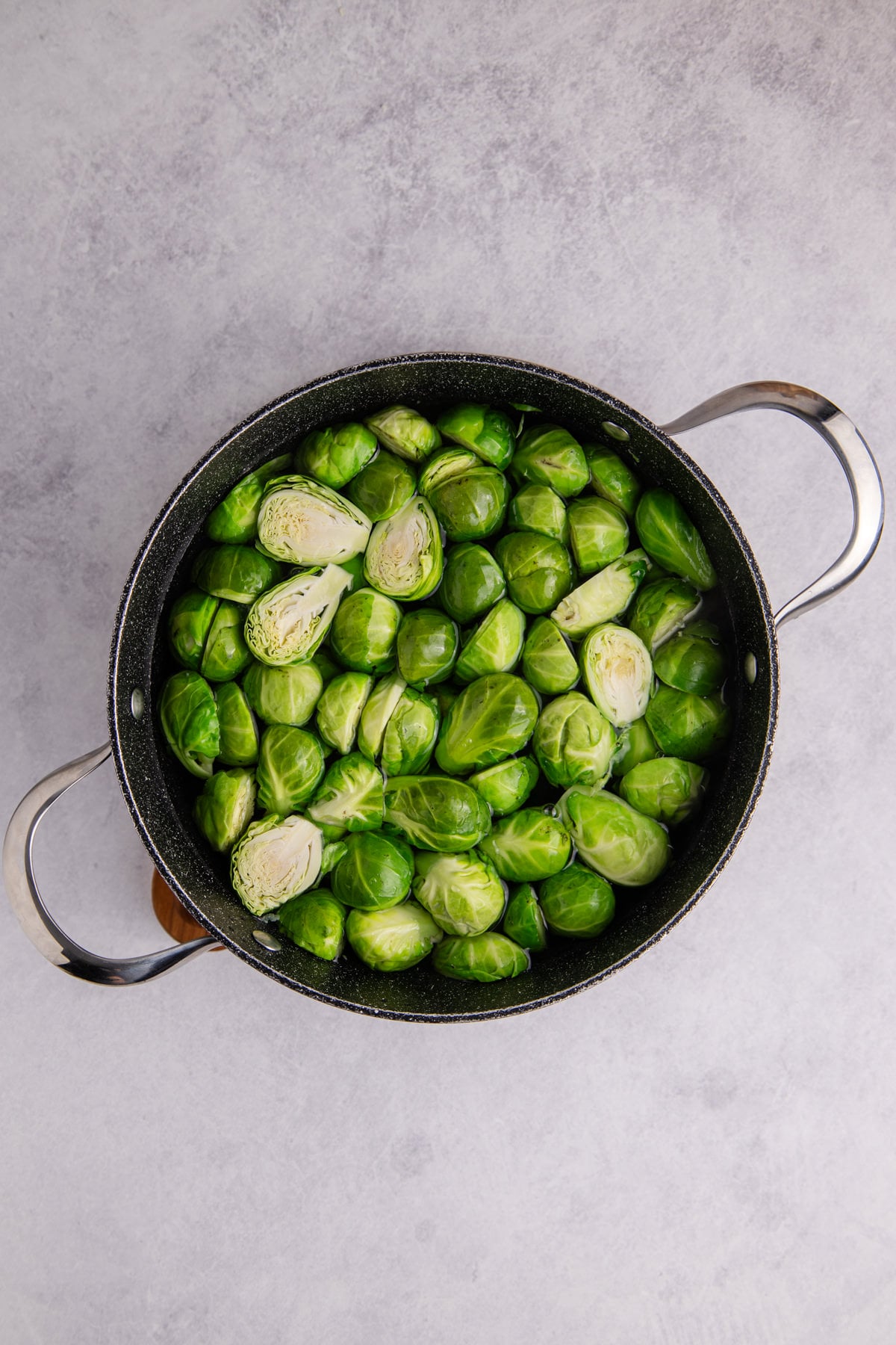 Brussels sprouts in a pot of water.