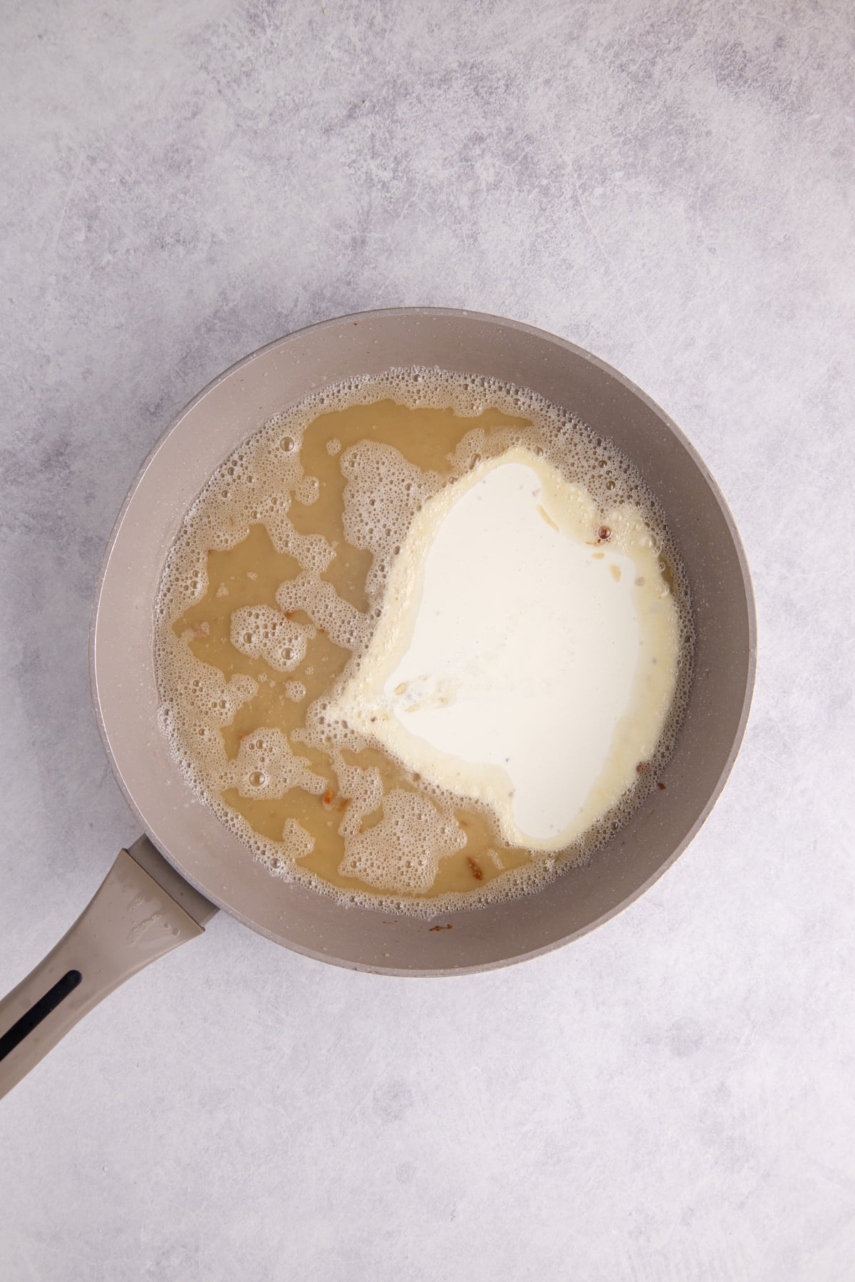 Heavy cream added to the bacon mixture.