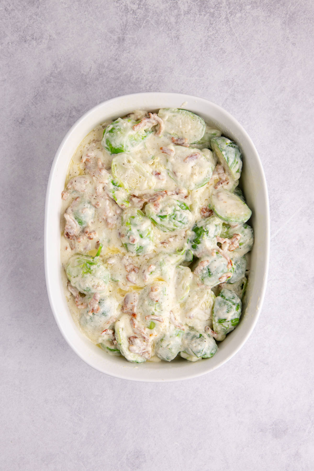 The Brussels sprouts mixture added to a casserole dish.