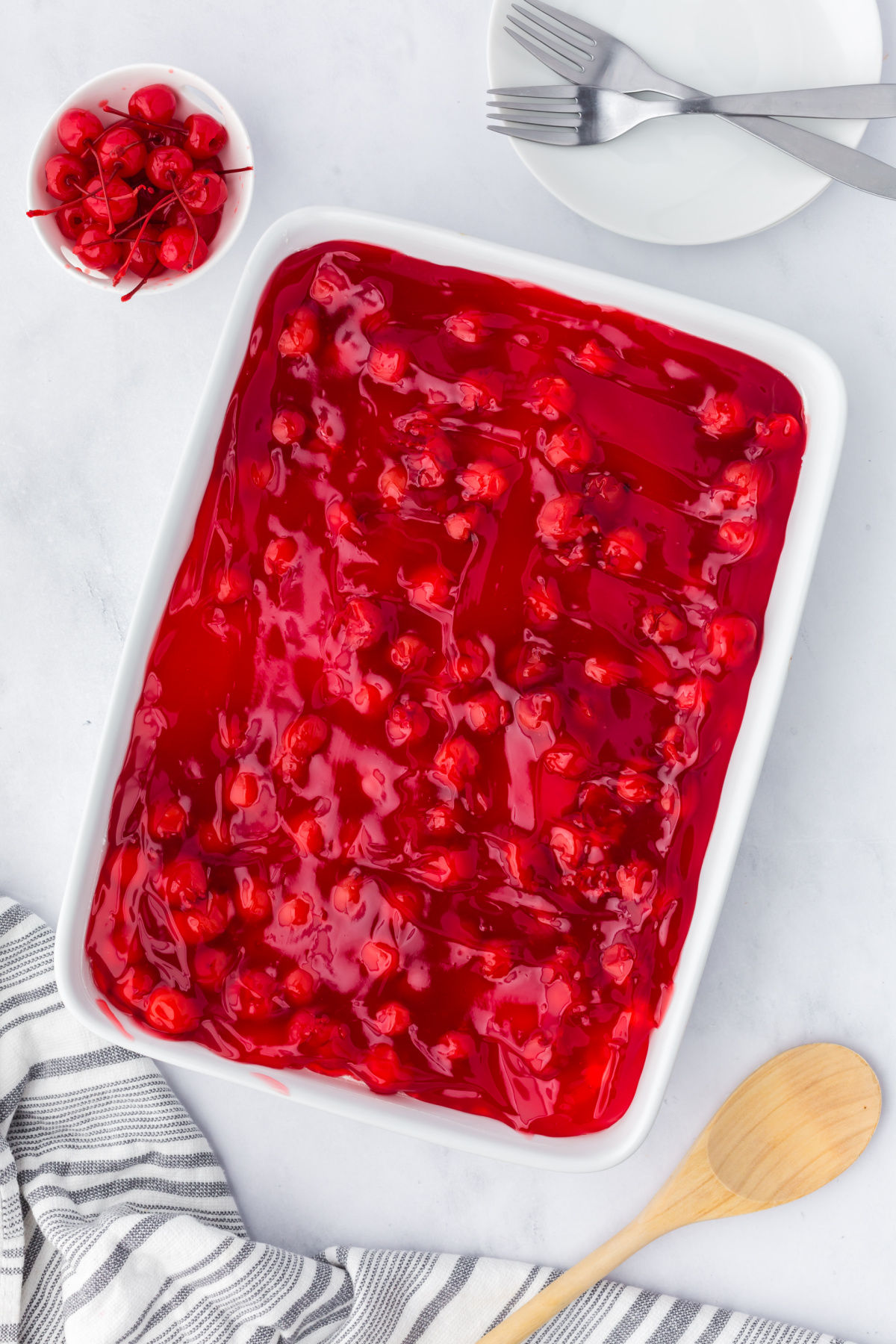 Cherry pie filling covering the top of the cream cheese mixture.