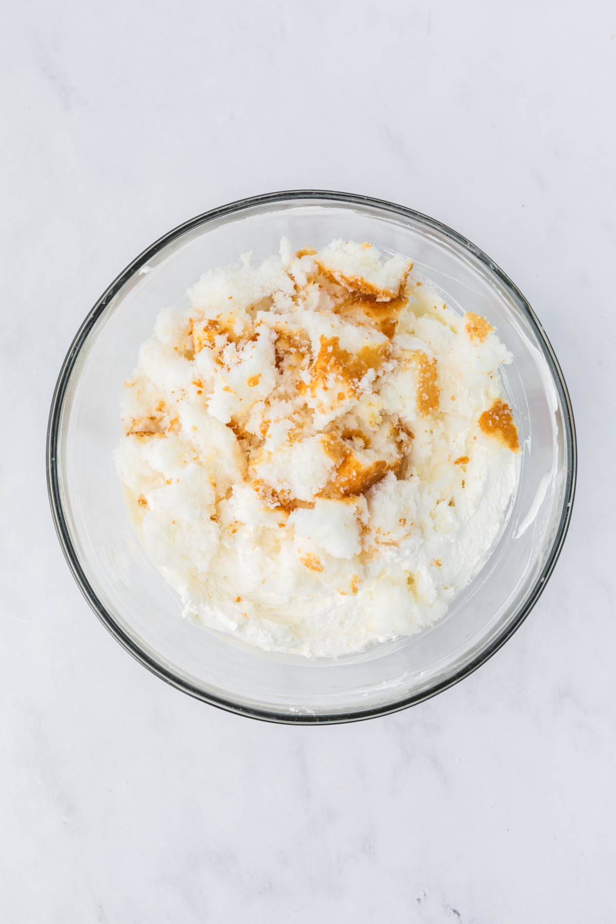 Pieces of angel food cake, whipped topping and almond extract added to the mixture.
