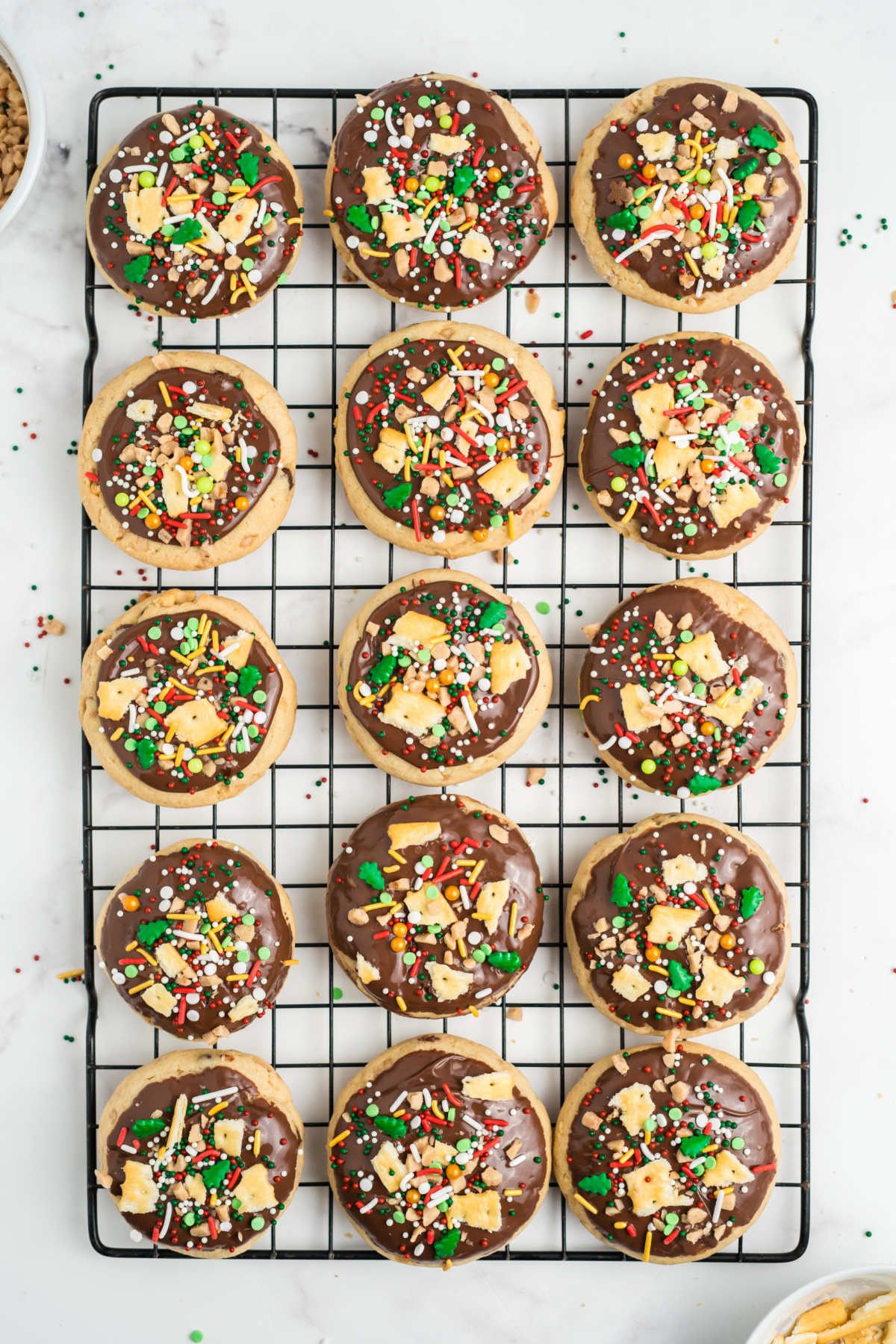 Melted chocolate added on top of each cookie and then some Saltine crumbs, toffee bits, and Christmas sprinkles added on top.