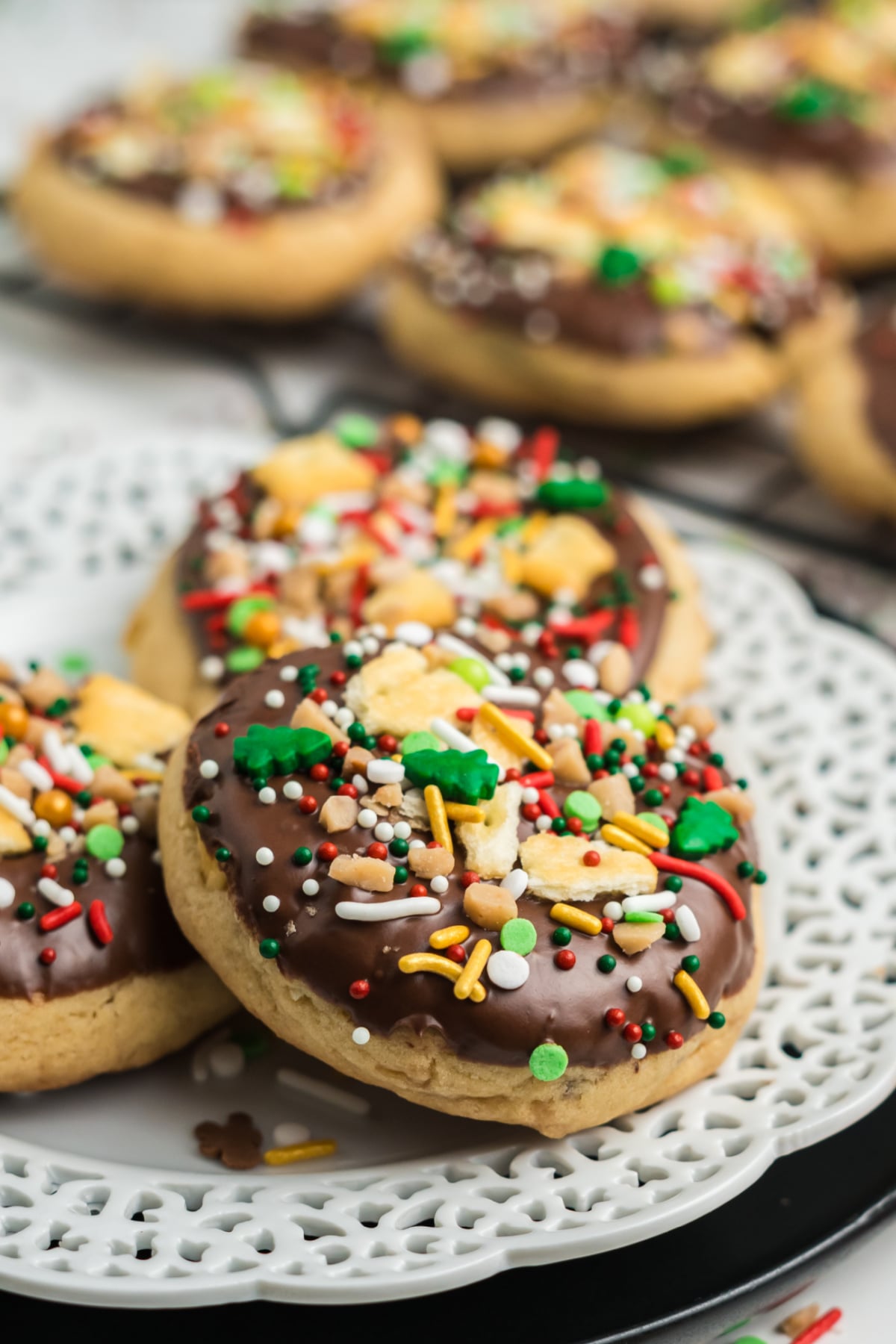 Cookies with sprinkles, crackers and decoration on a plate.