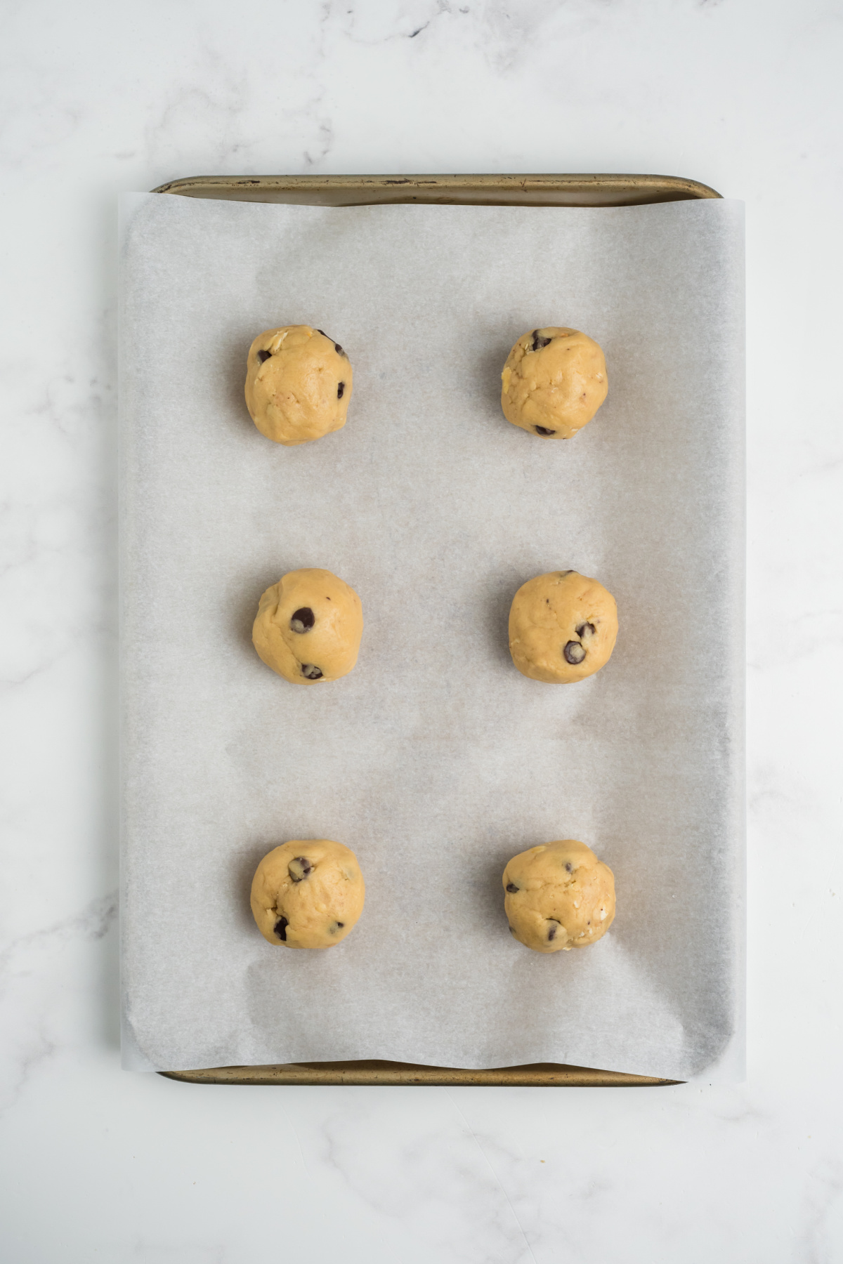 Dough balls formed on a cookie sheet.