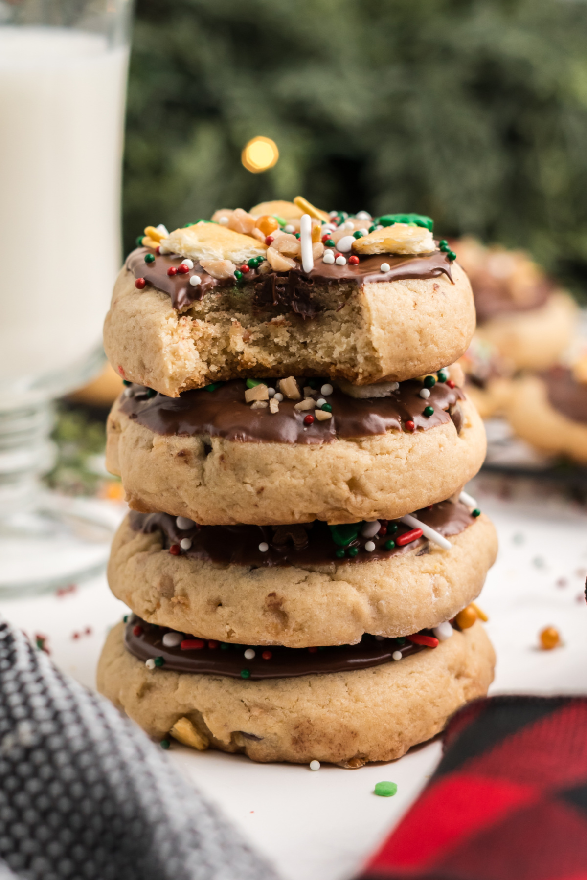 A stack of cookies with chocolate on top.
